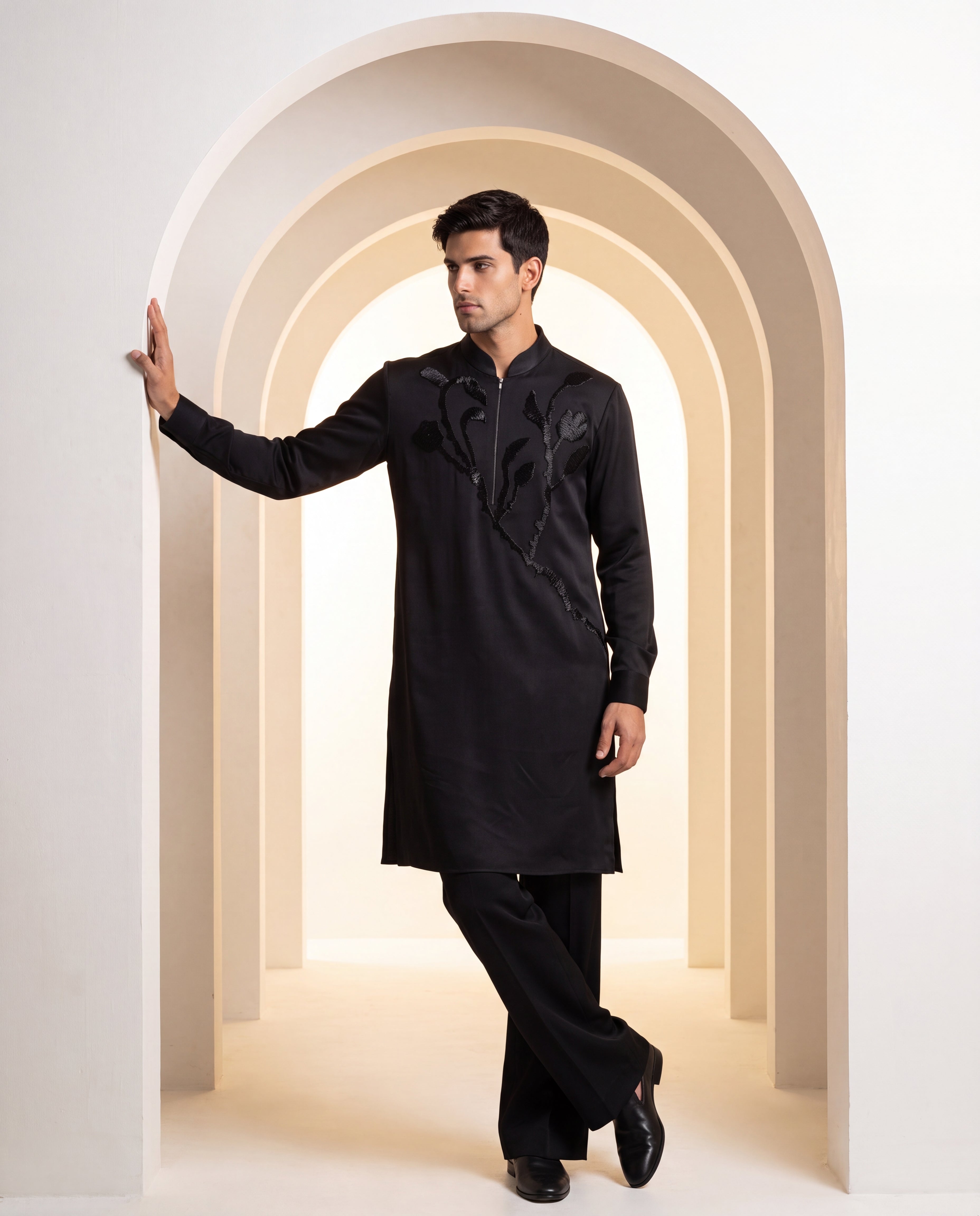 Black knit kurta with monotone floral embroidery detailing, paired with matching knit palazzo.
