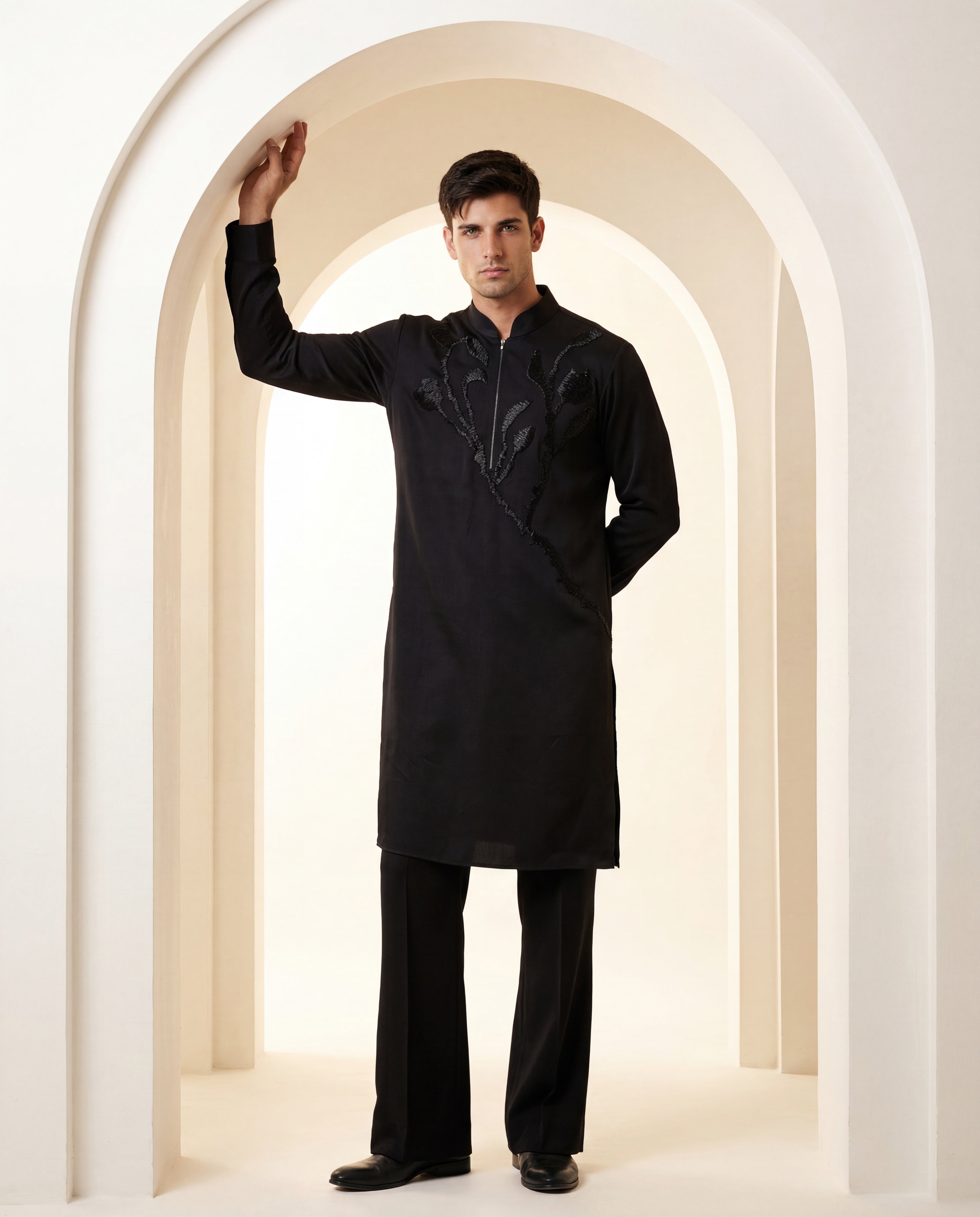 Black knit kurta with monotone floral embroidery detailing, paired with matching knit palazzo.