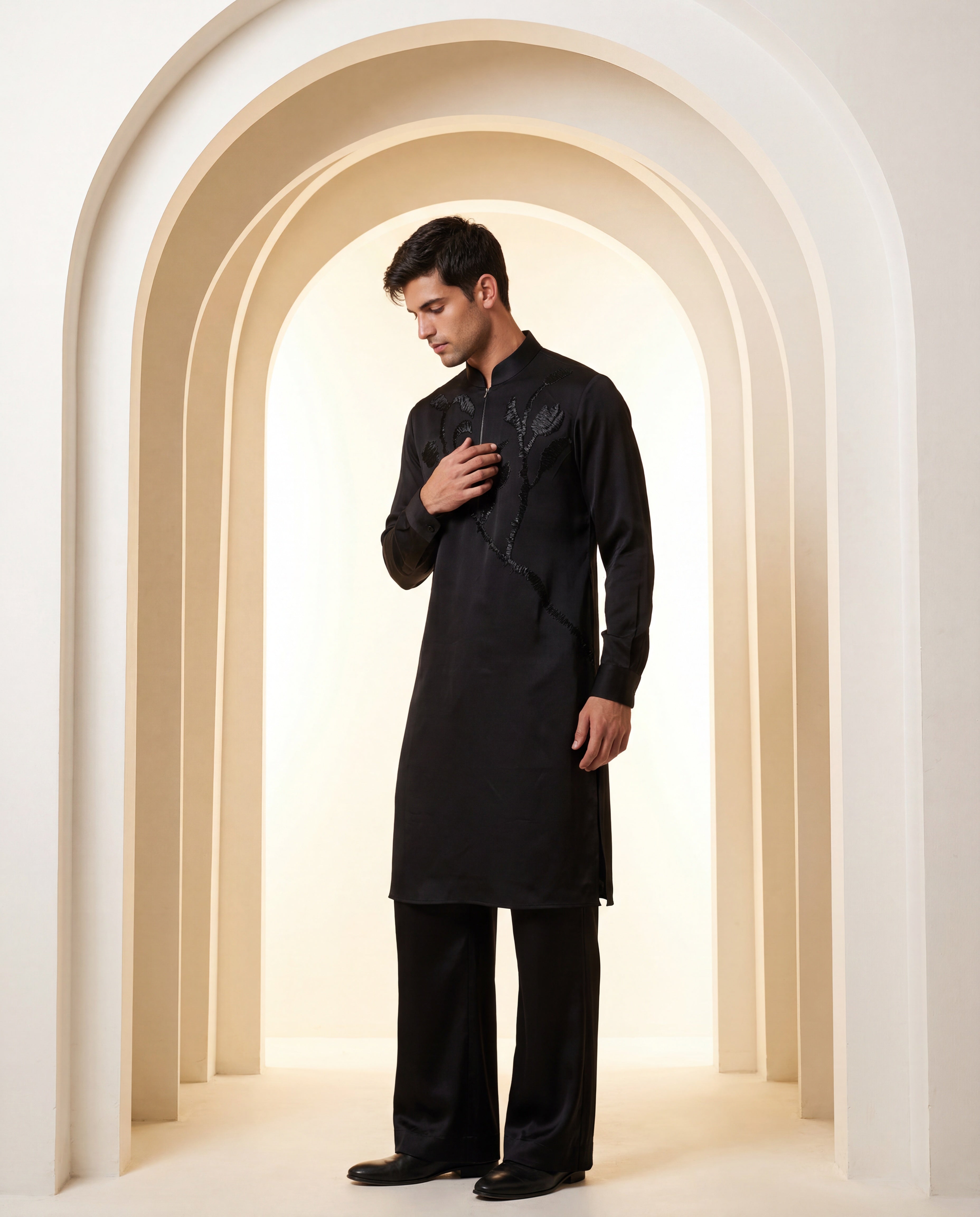 Black knit kurta with monotone floral embroidery detailing, paired with matching knit palazzo.