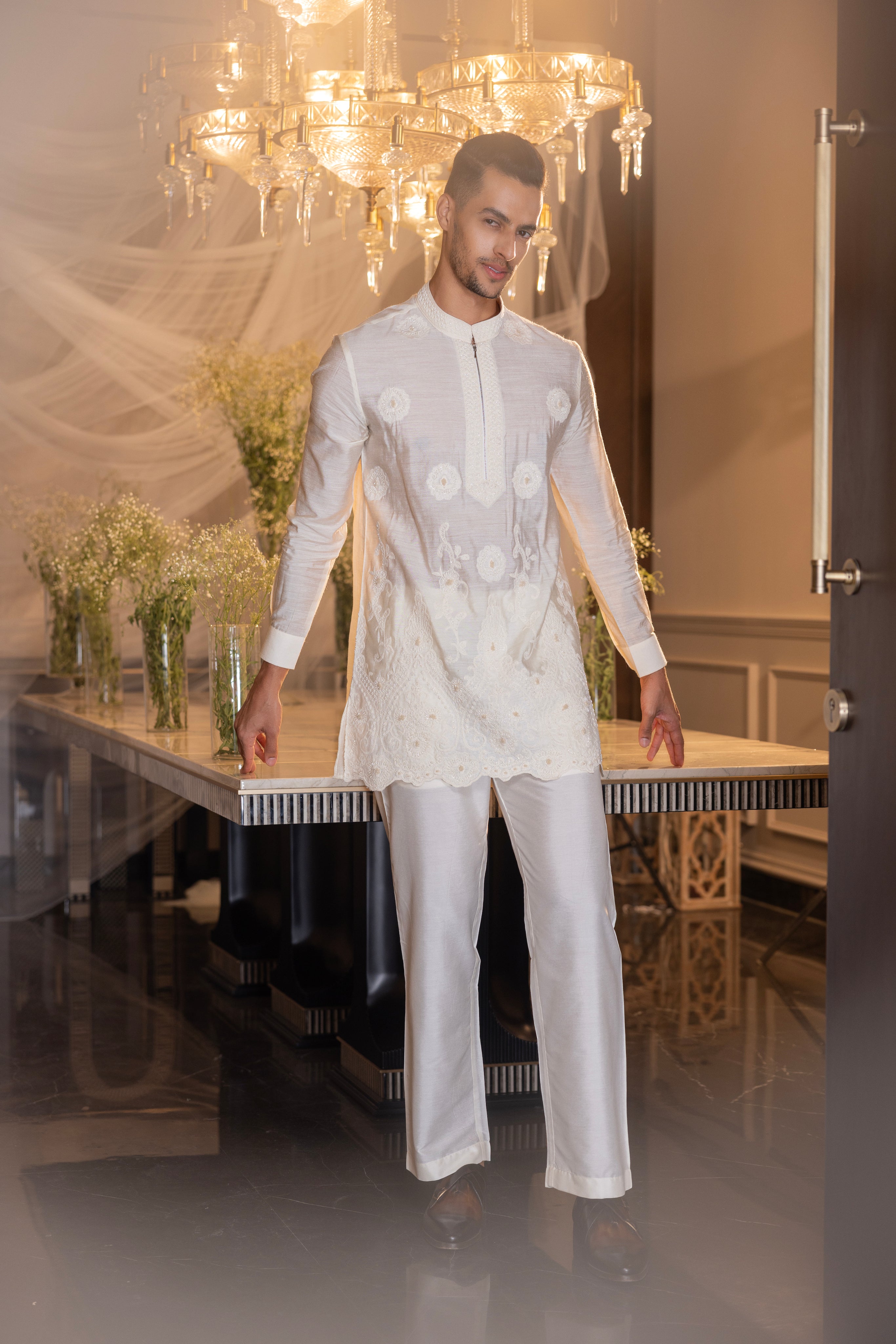 Cream hand-embroidered short kurta paired with a matching aligadhi.
