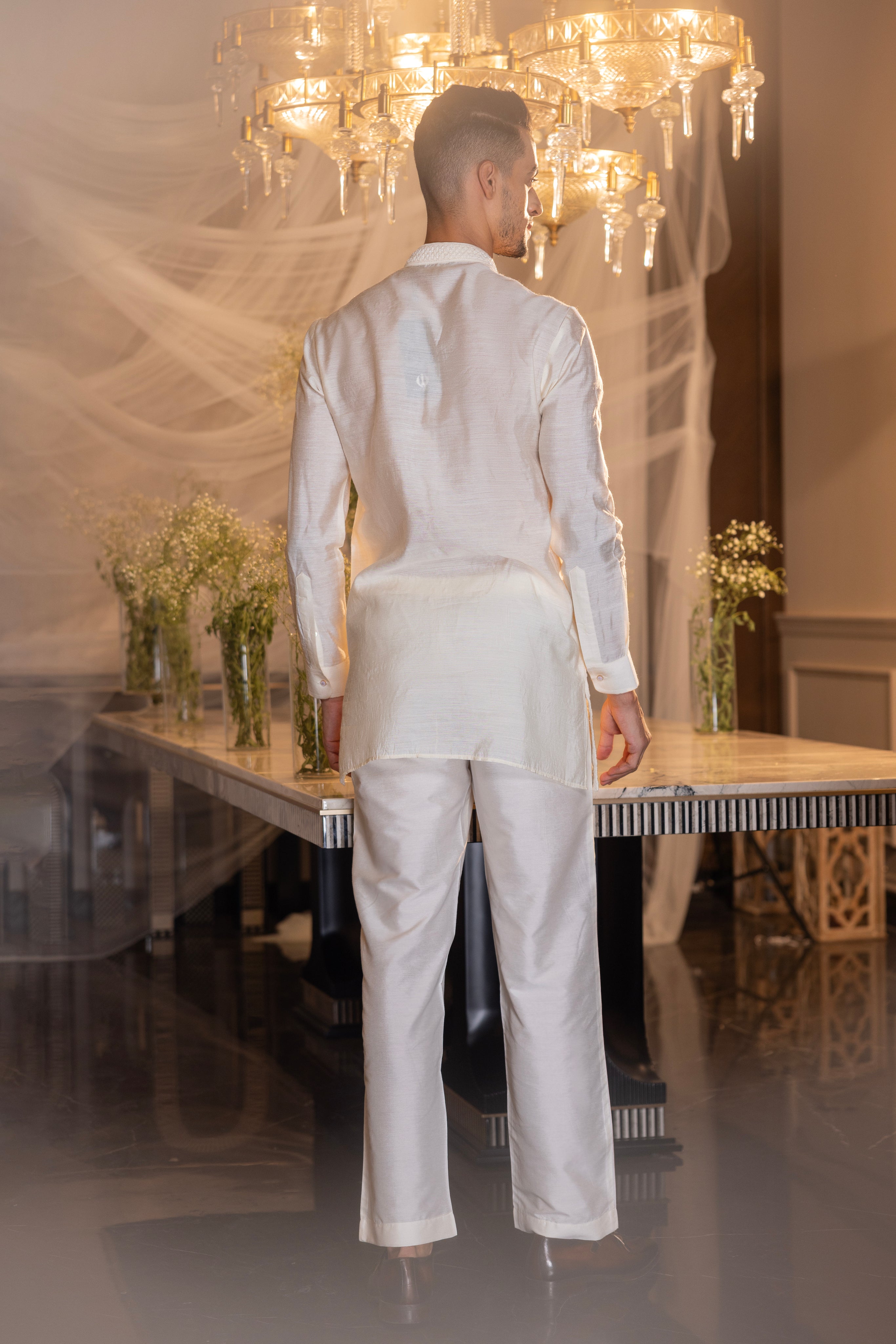Cream hand-embroidered short kurta paired with a matching aligadhi.