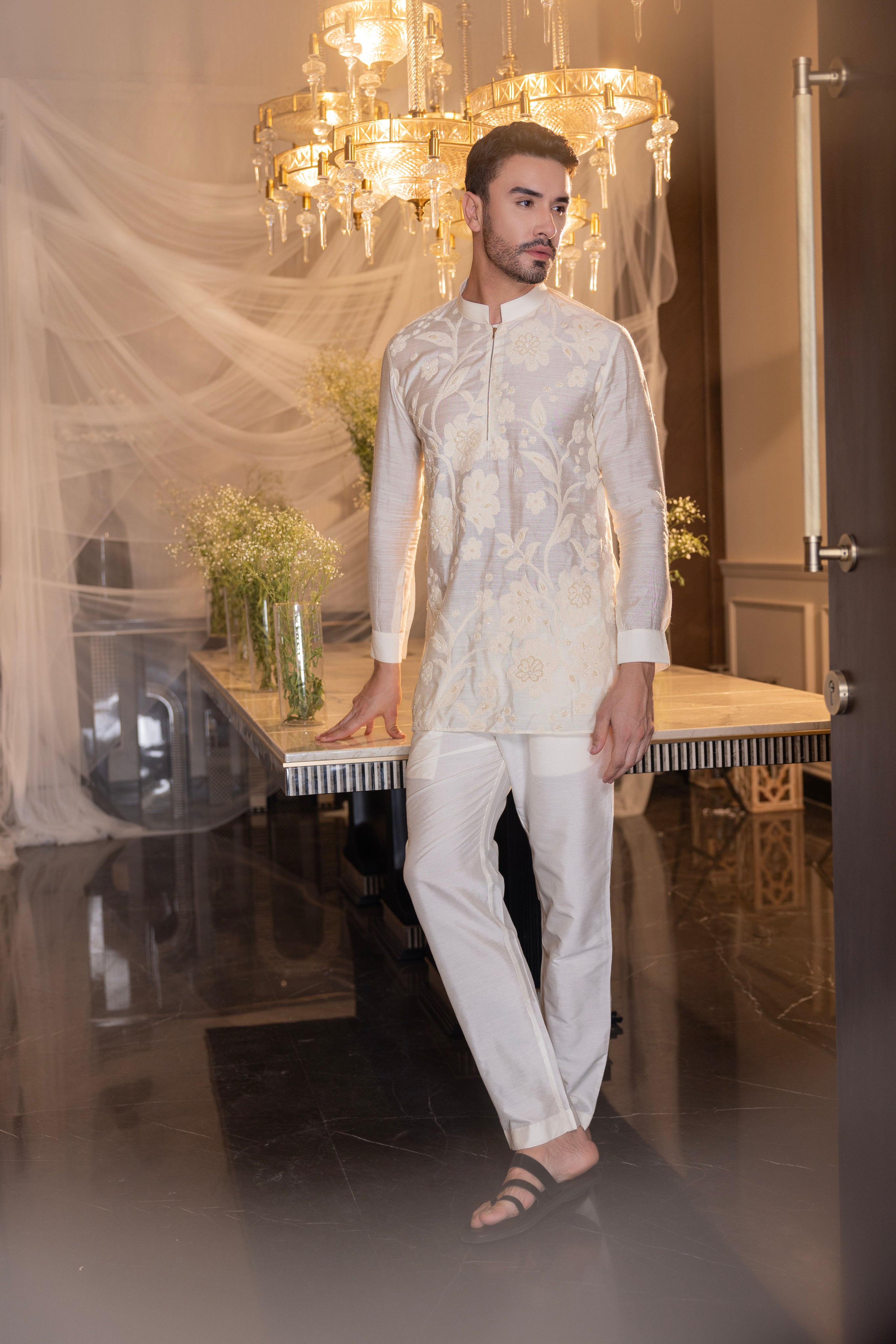 Cream hand-embroidered short kurta paired with a matching aligadhi.