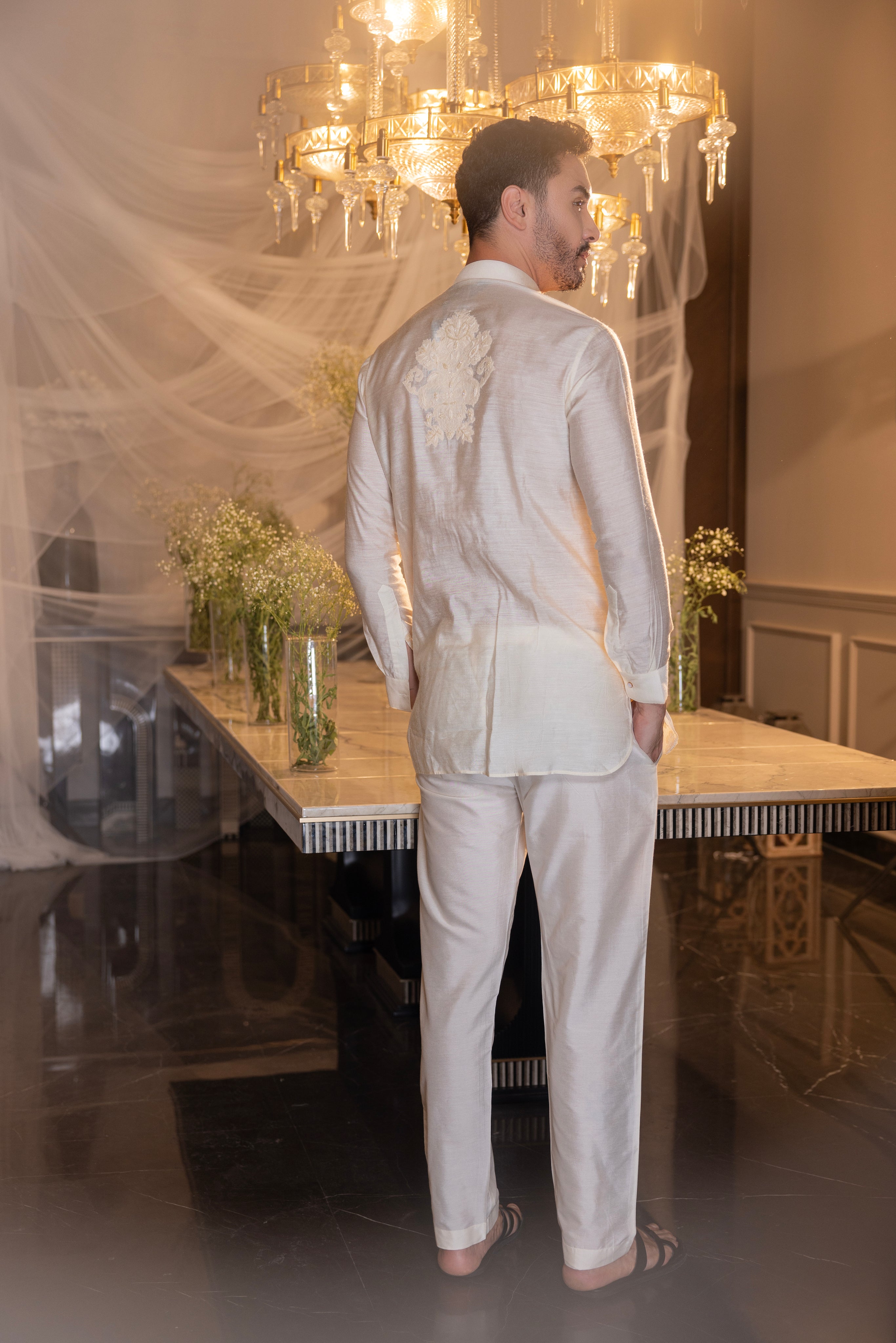 Cream hand-embroidered short kurta paired with a matching aligadhi.