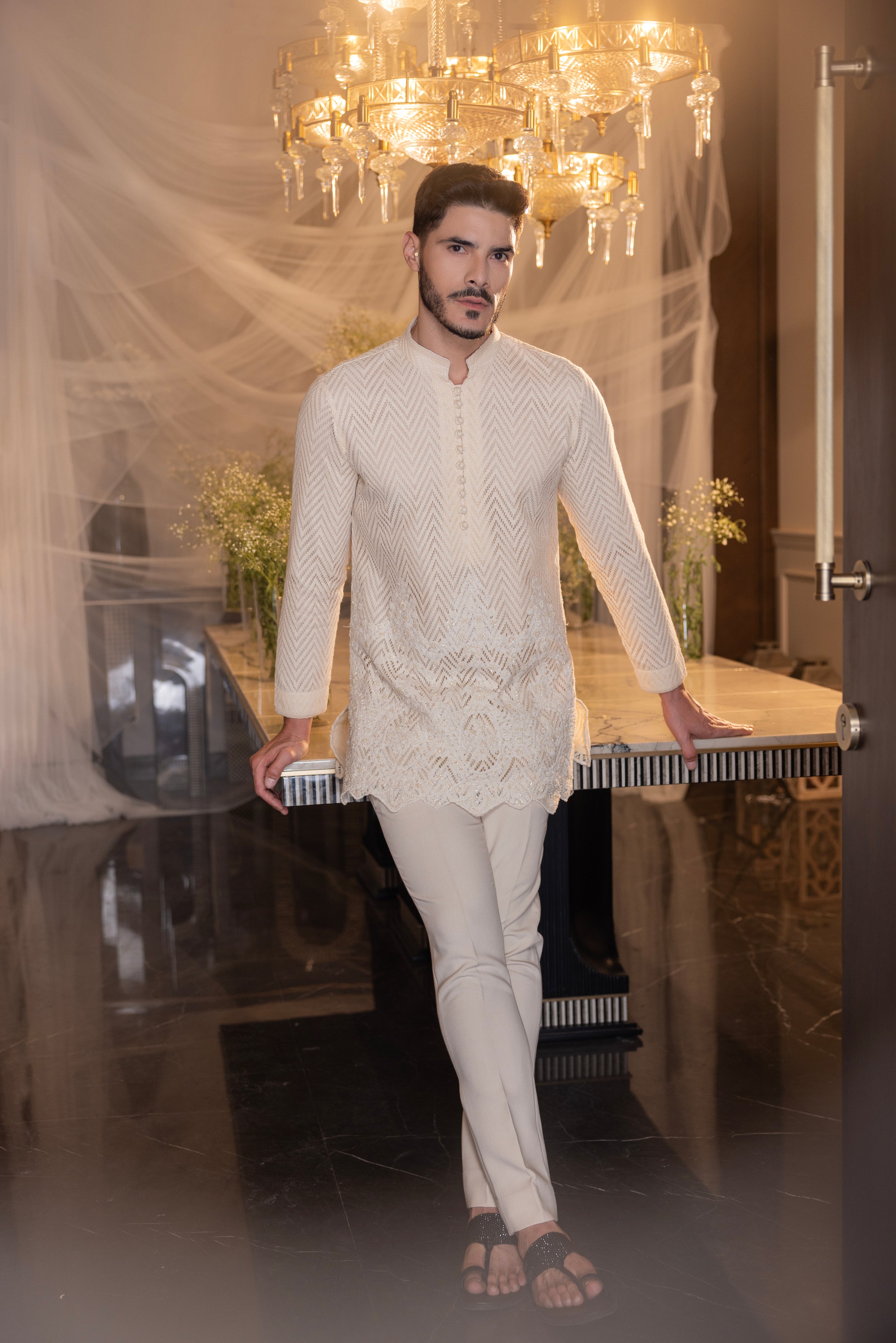 Cream hand-embroidered crochet short kurta paired with a matching pant.