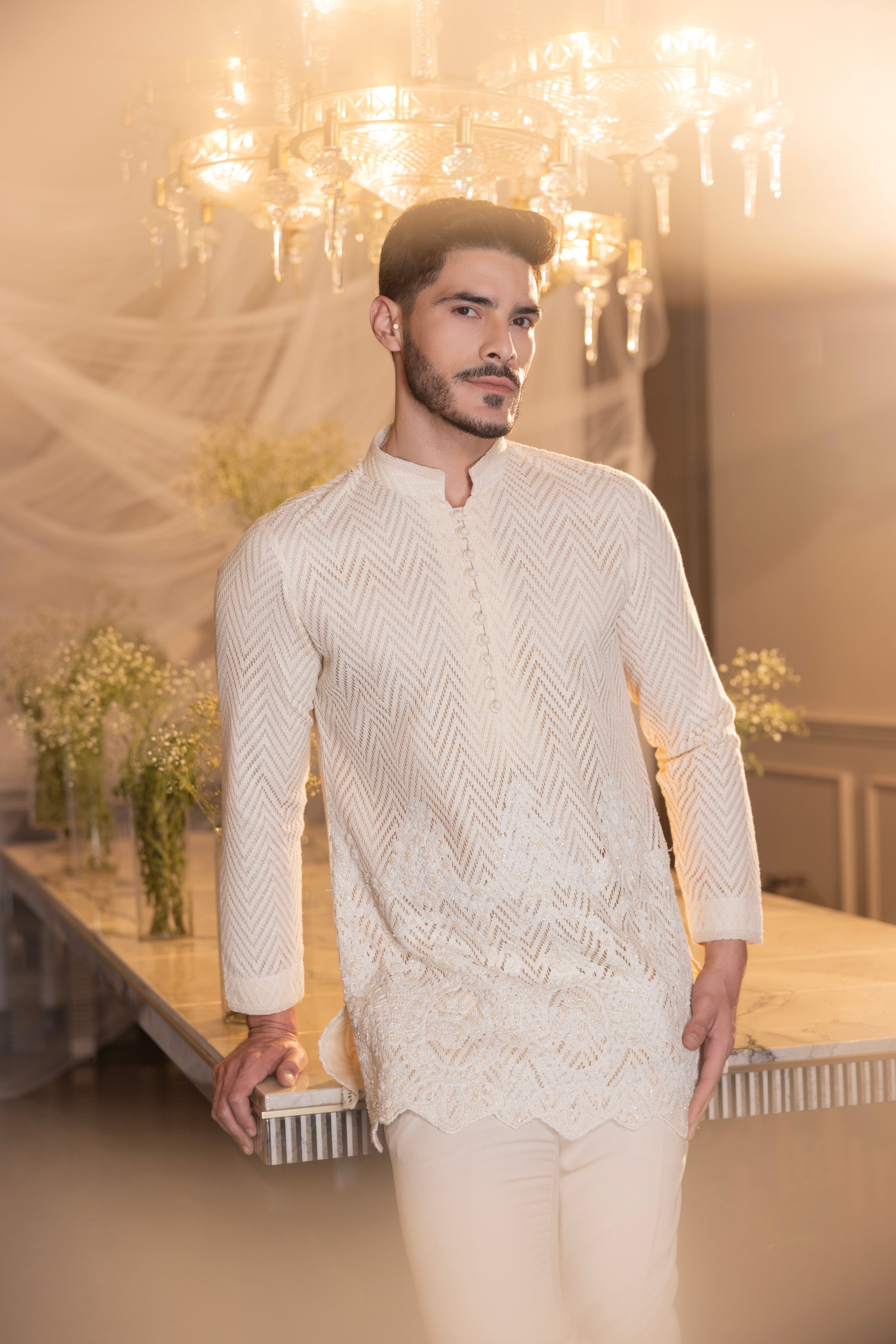 Cream hand-embroidered crochet short kurta paired with a matching pant.
