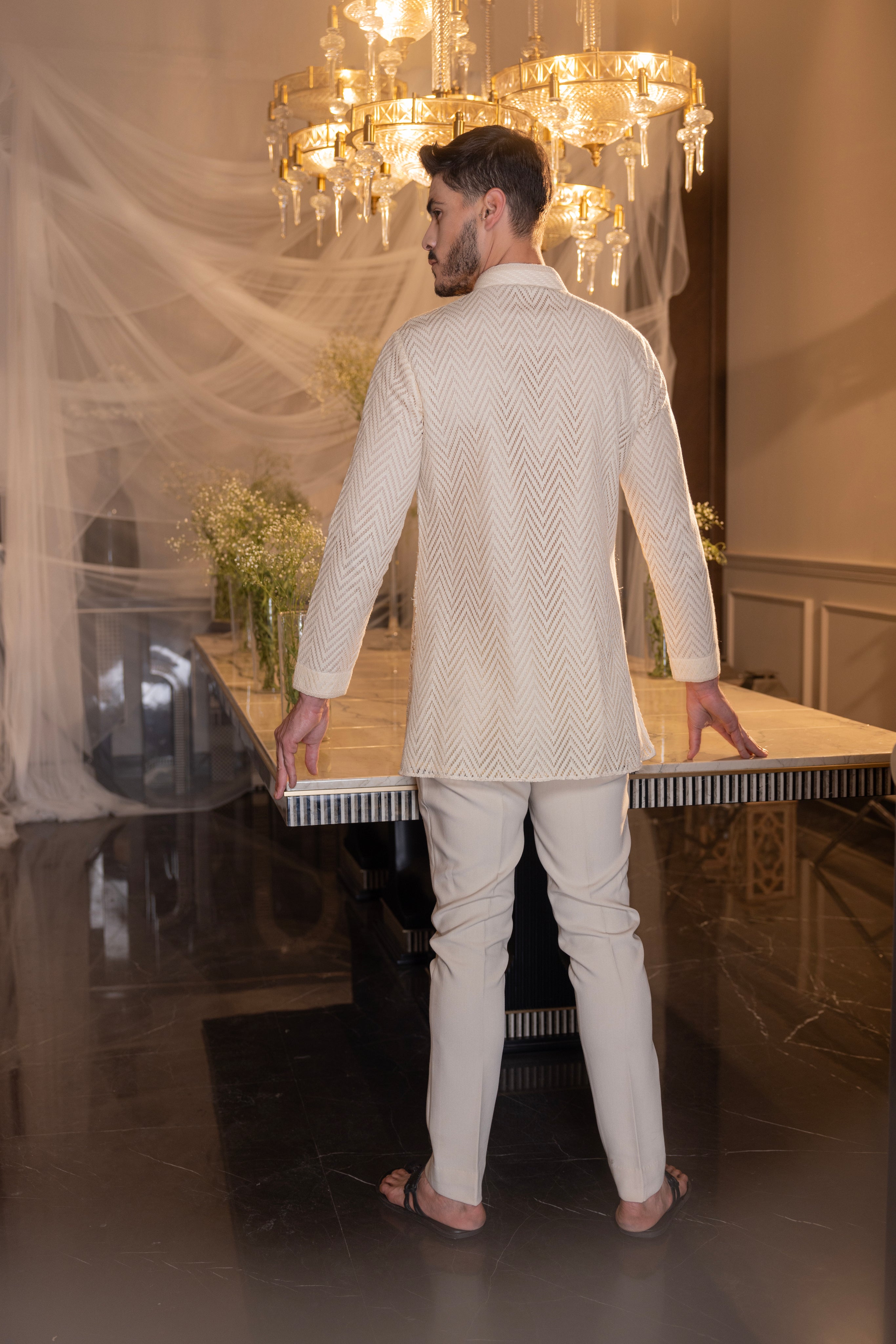 Cream hand-embroidered crochet short kurta paired with a matching pant.