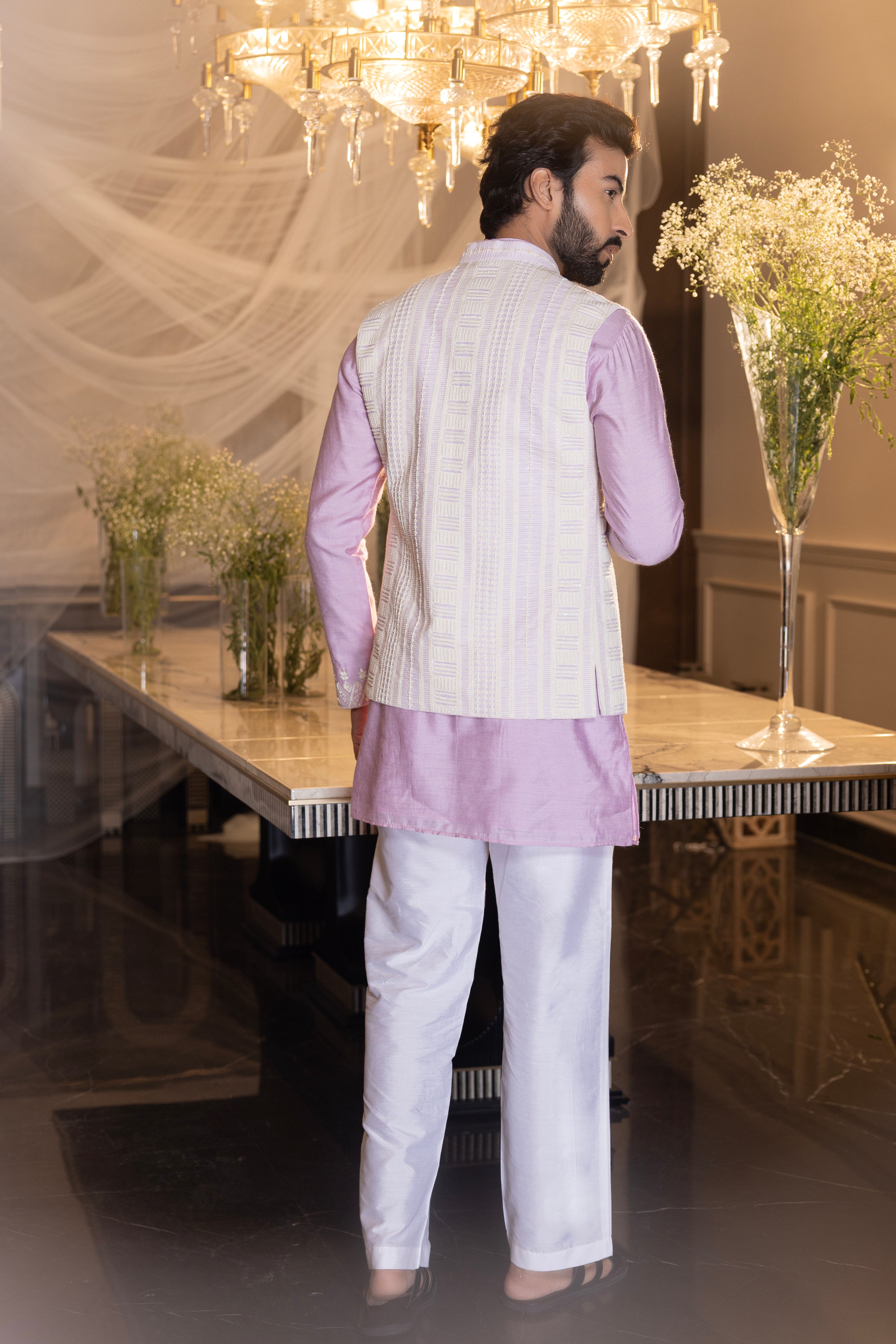 Lilac Crochet hand embroidered waistcoat   paired with an embrodered kurta and aligadhi.