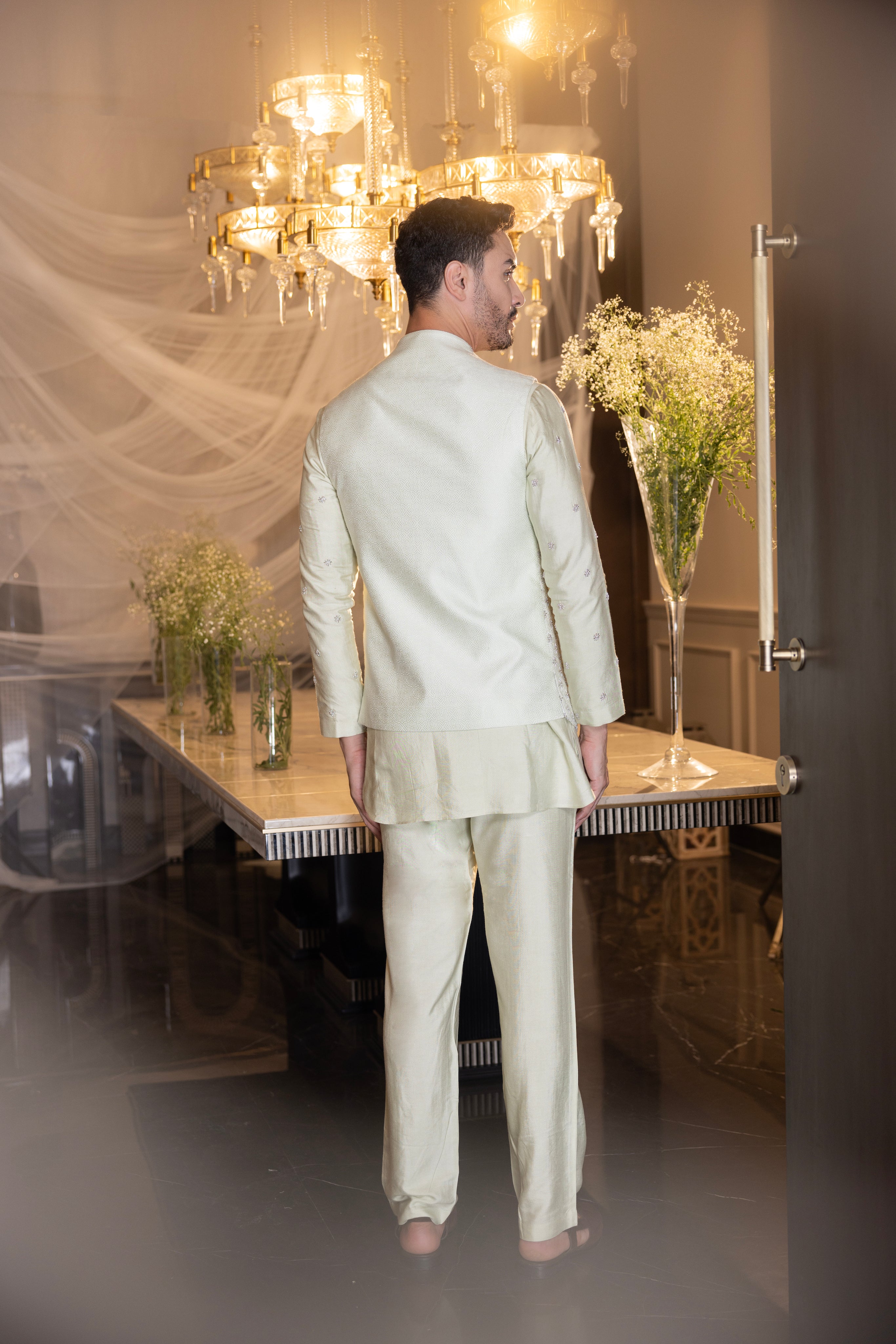 Banarasi Silk Mint Green hand-embroidered  waistcoat  paired with an embroidered kurta and matching aligadhi.