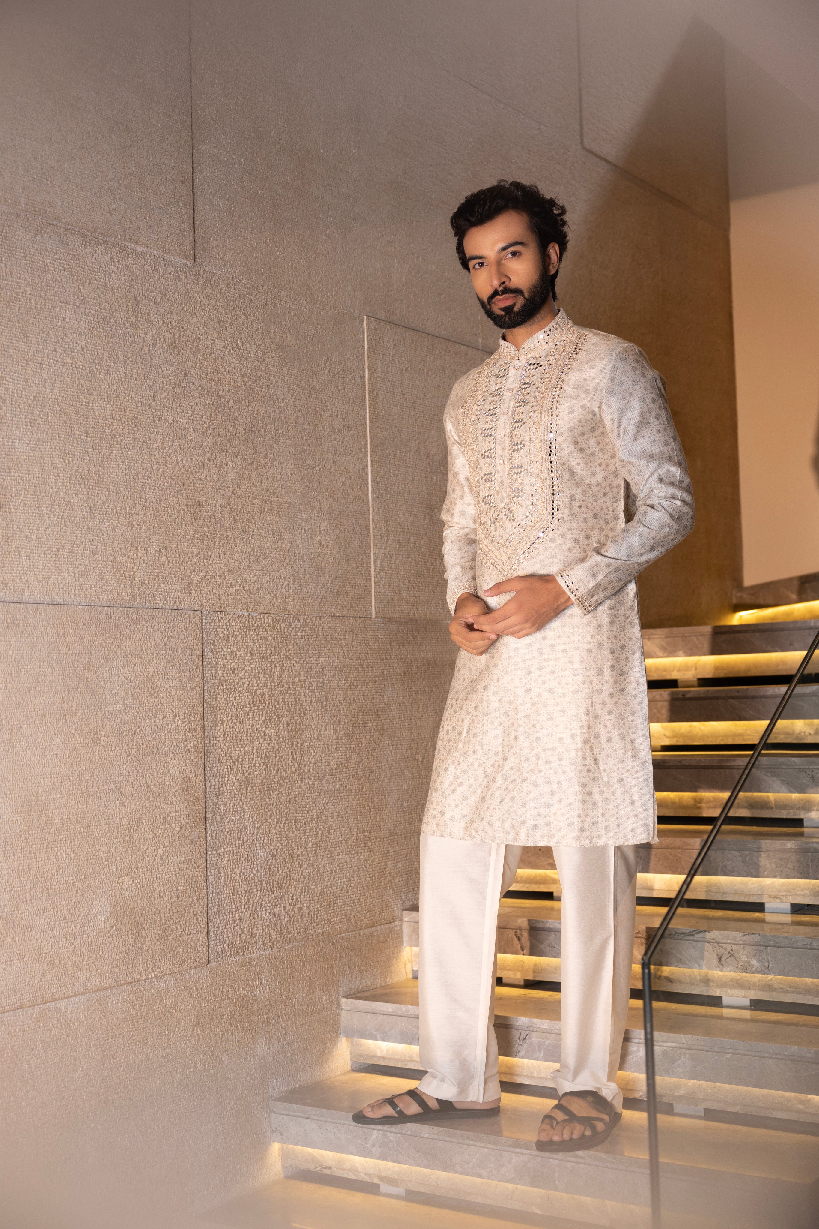 Cream floral digital print kurta accentuated with mirror work paired with a plain aligadhi.