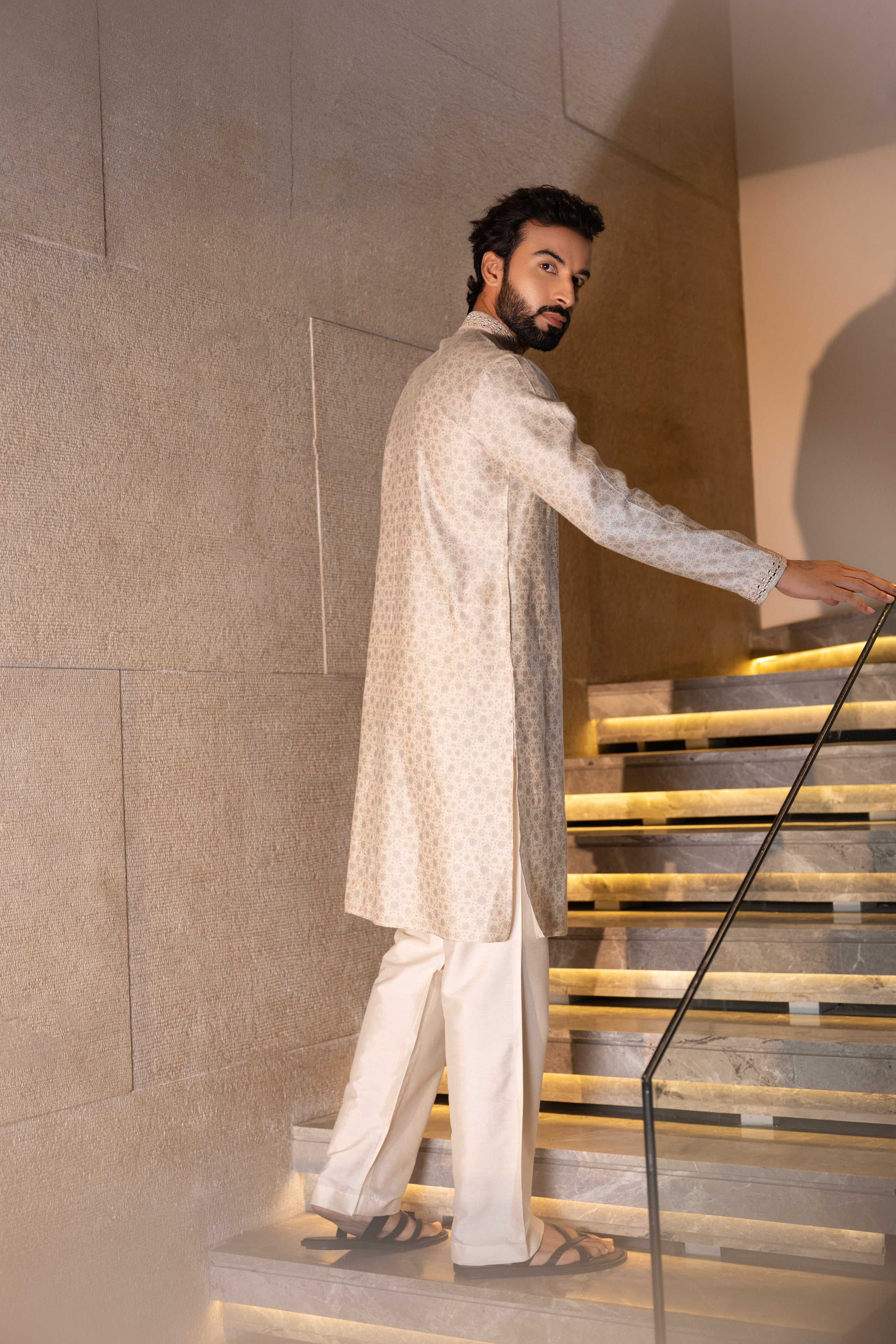 Cream floral digital print kurta accentuated with mirror work paired with a plain aligadhi.