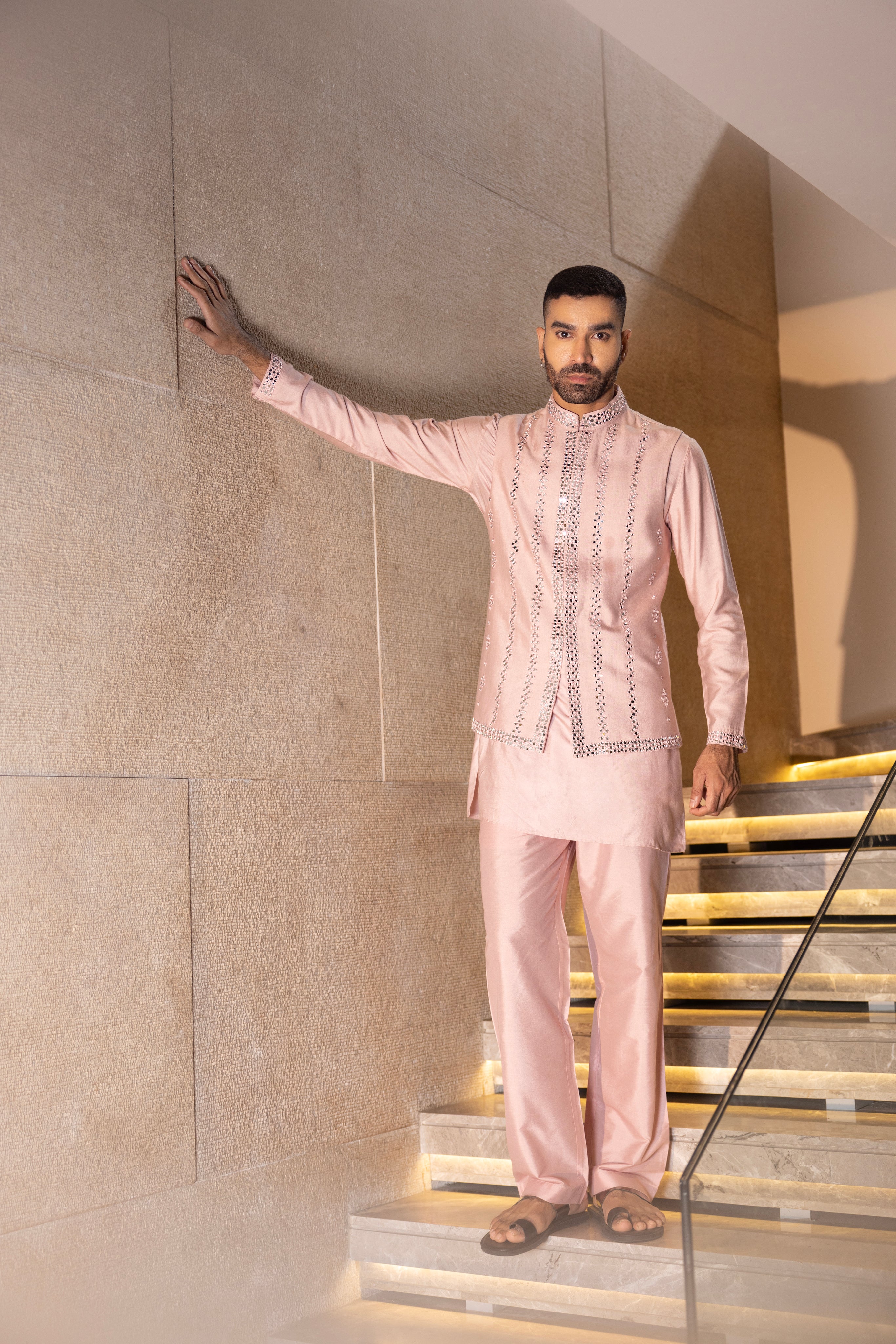 Baby pink mirror work waistcoat  paired with a  matching kurta & aligadhi.