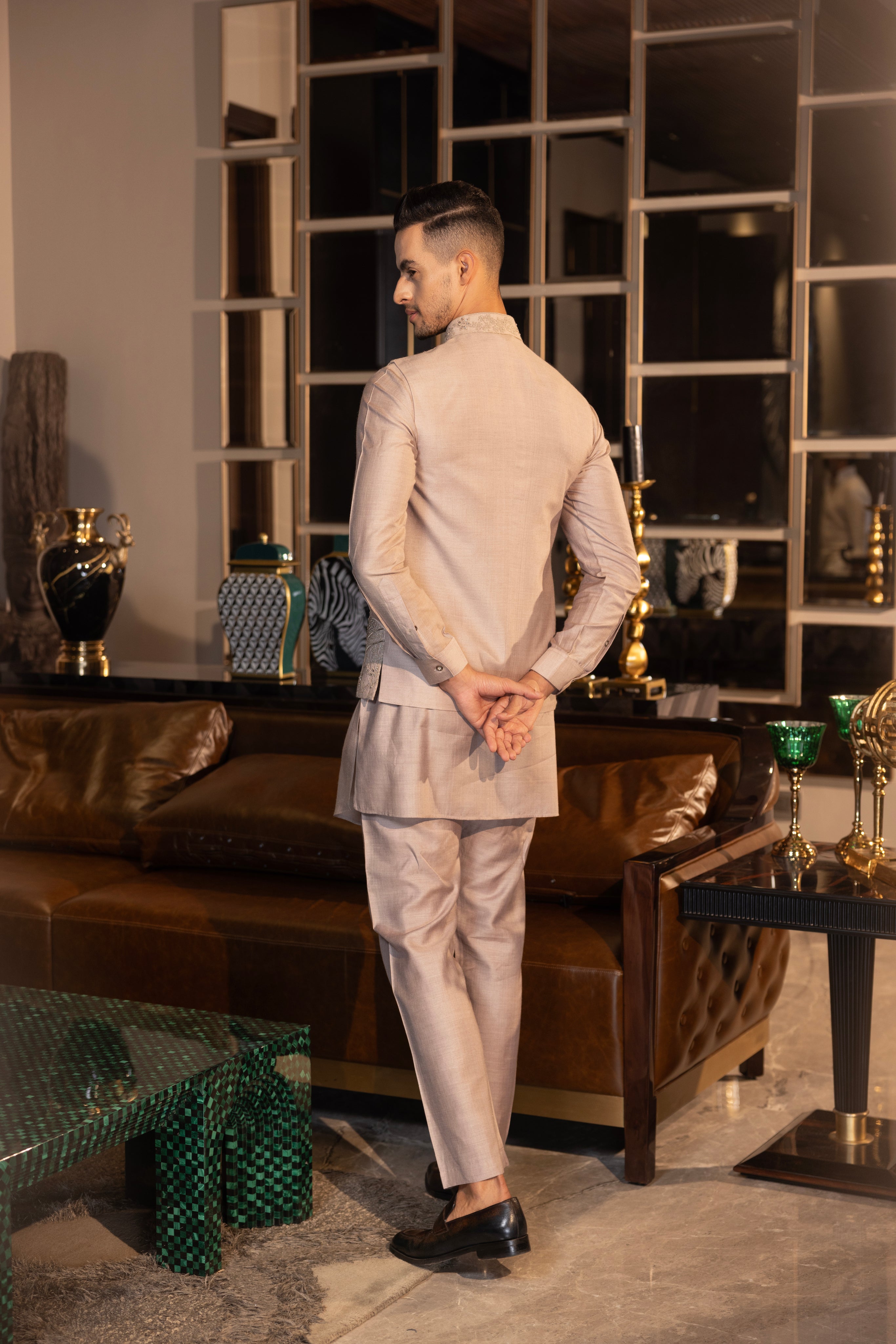 Mouse colour waistcoat with intricate montone hand-embroidery paired with a matching kurta and aligadhi set.