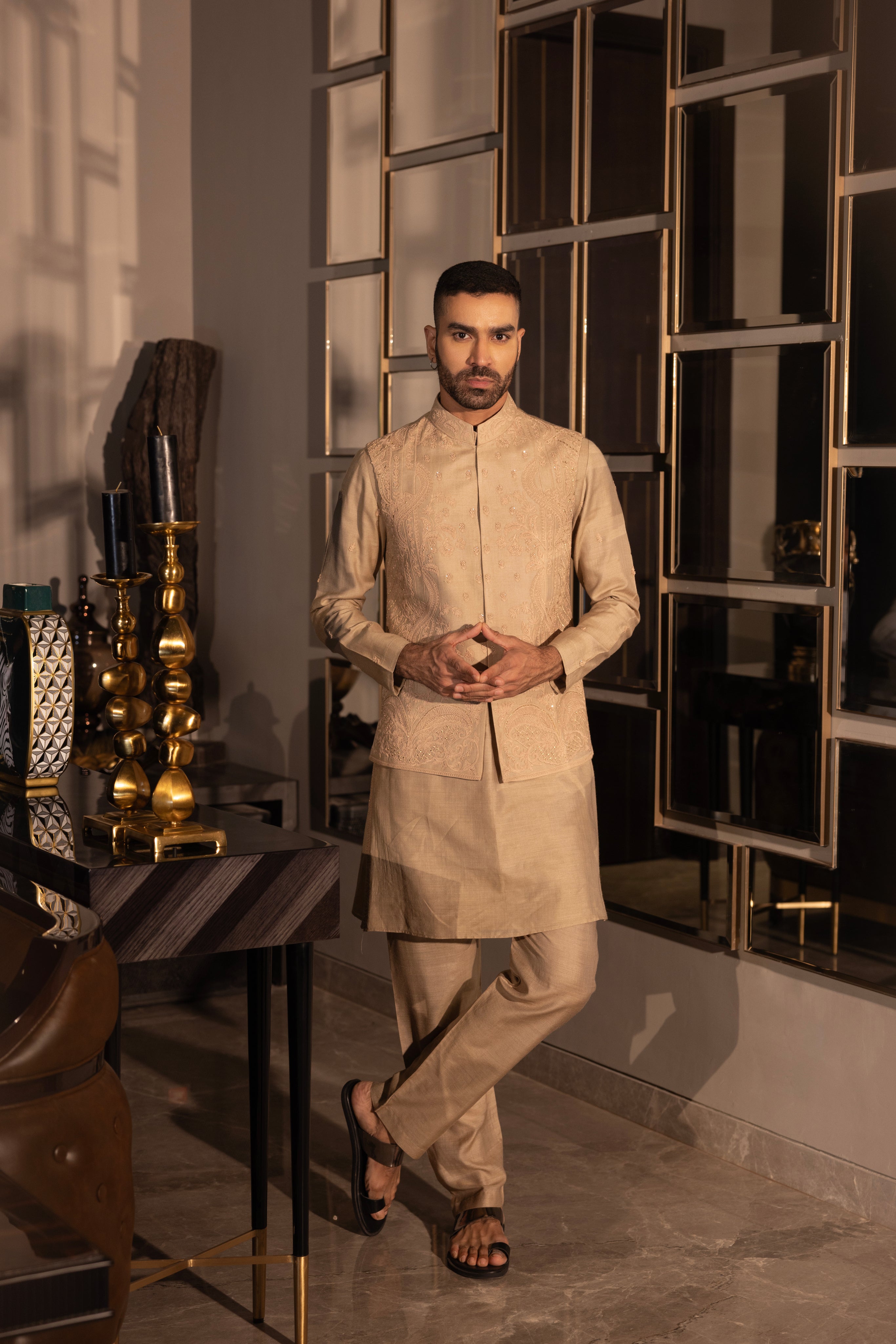 Khakhi waistcoat with intricate montone hand-embroidery paired with a matching kurta and aligadhi set.