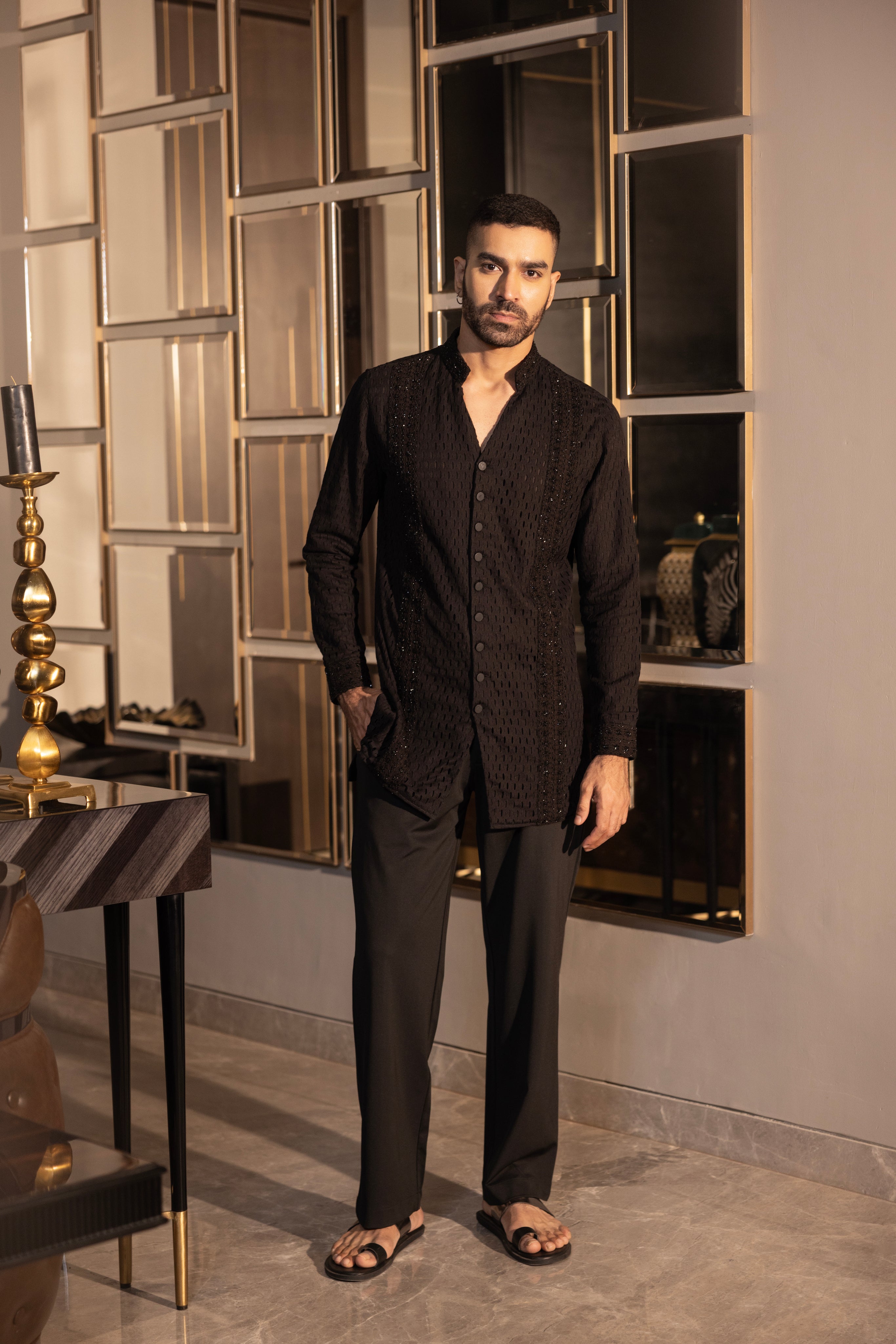 Hand-embroidered black crochet short kurta paired with a matching aligadhi set.