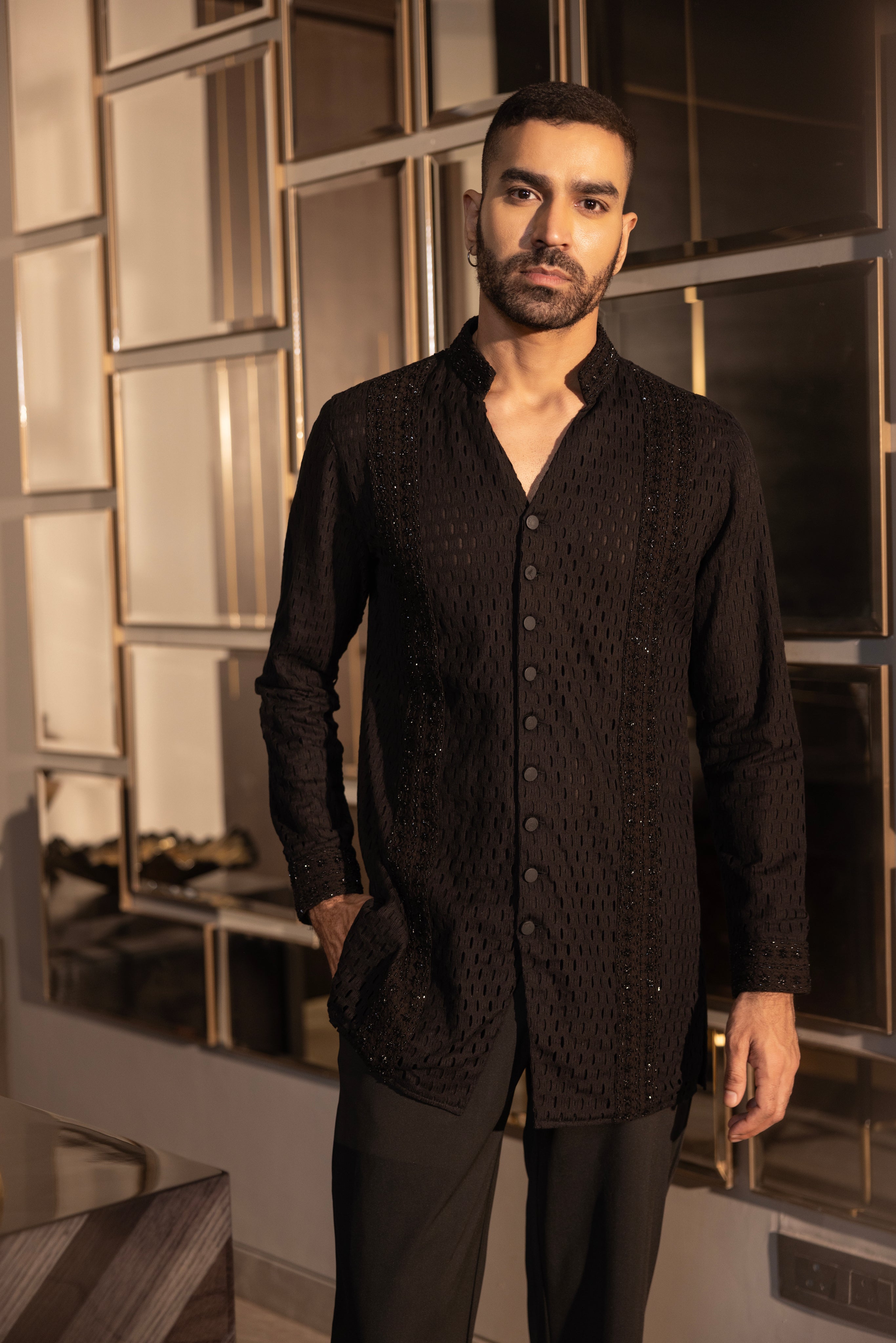 Hand-embroidered black crochet short kurta paired with a matching aligadhi set.