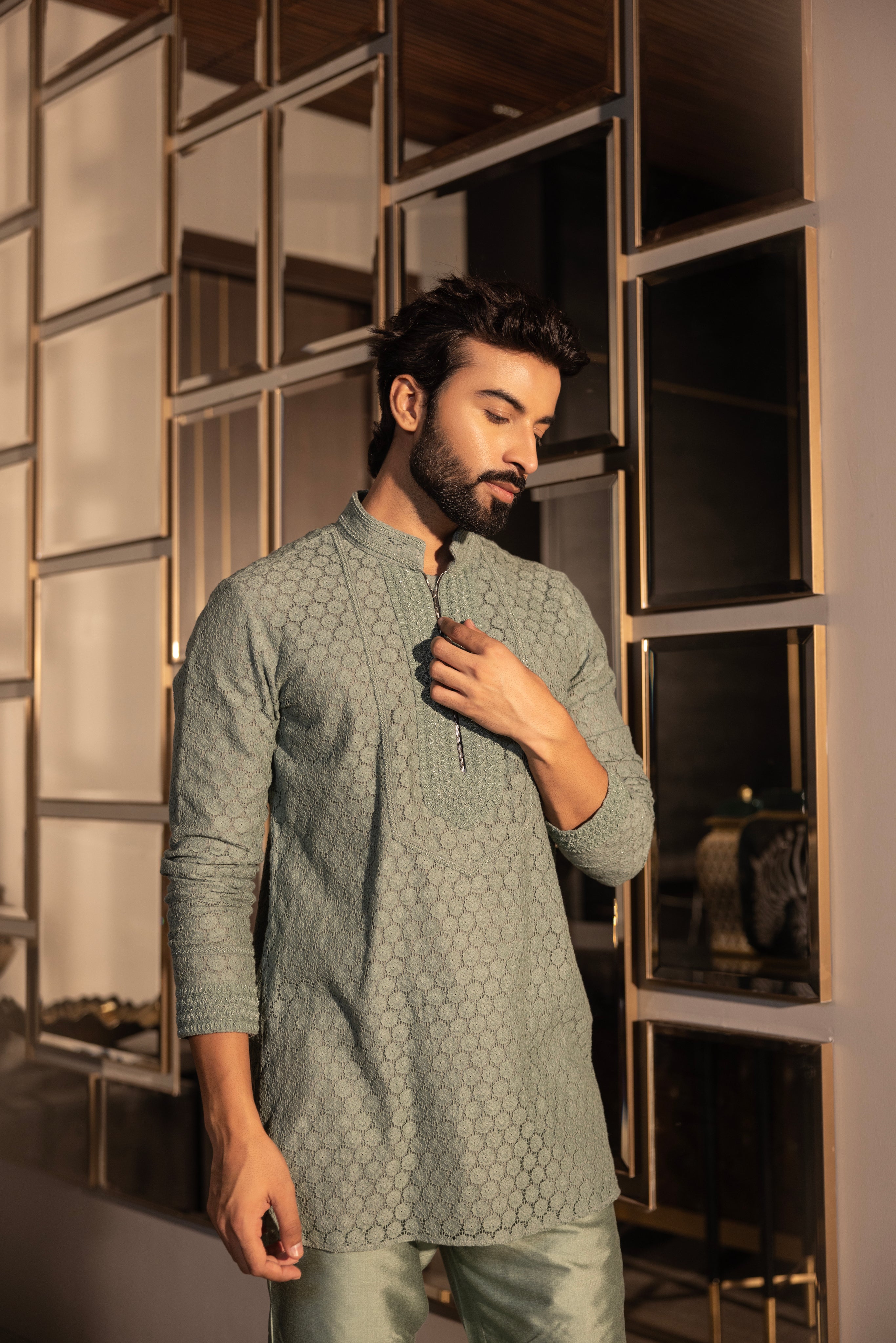 Hand-embroidered green crochet short kurta paired with a matching aligadhi set.