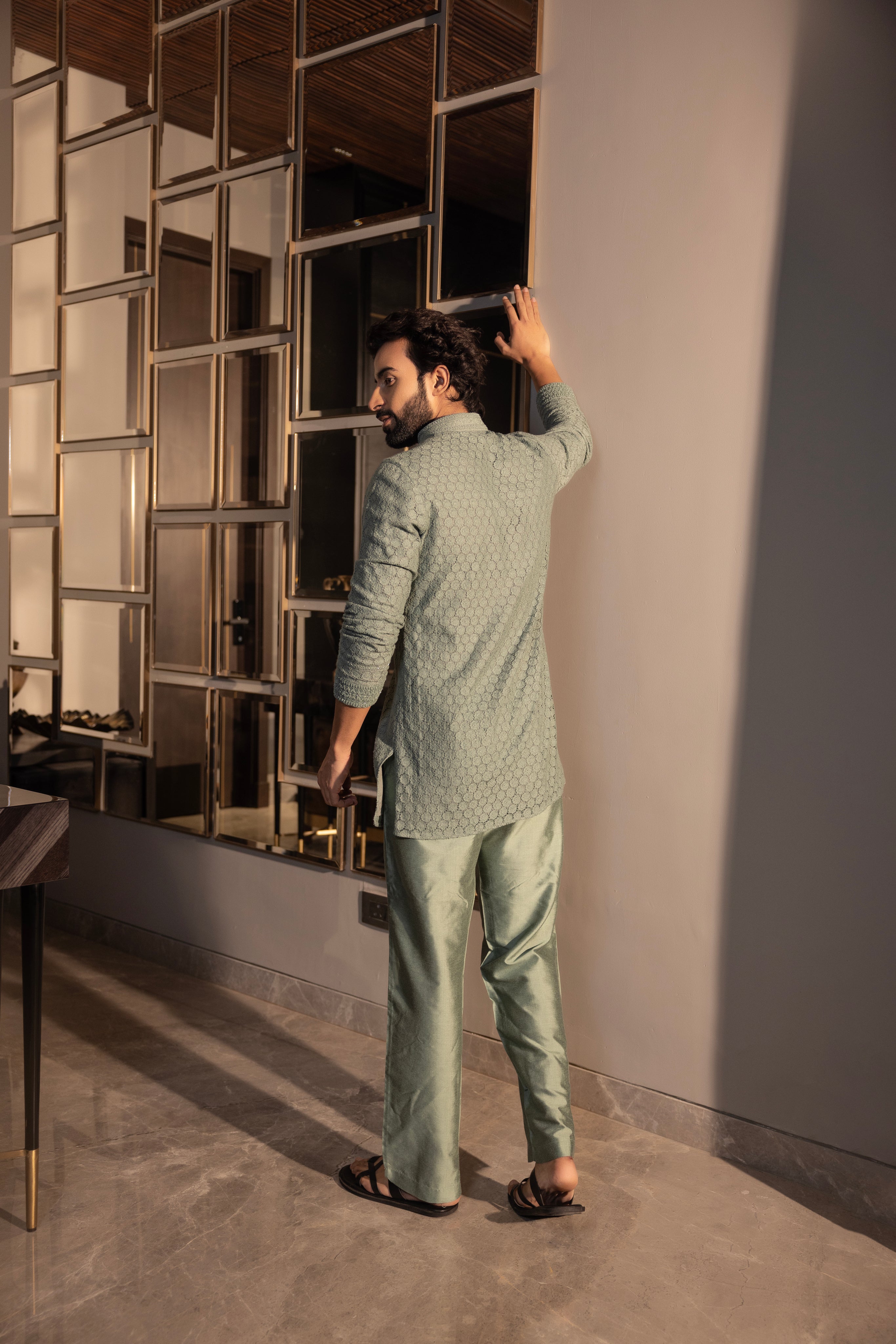 Hand-embroidered green crochet short kurta paired with a matching aligadhi set.