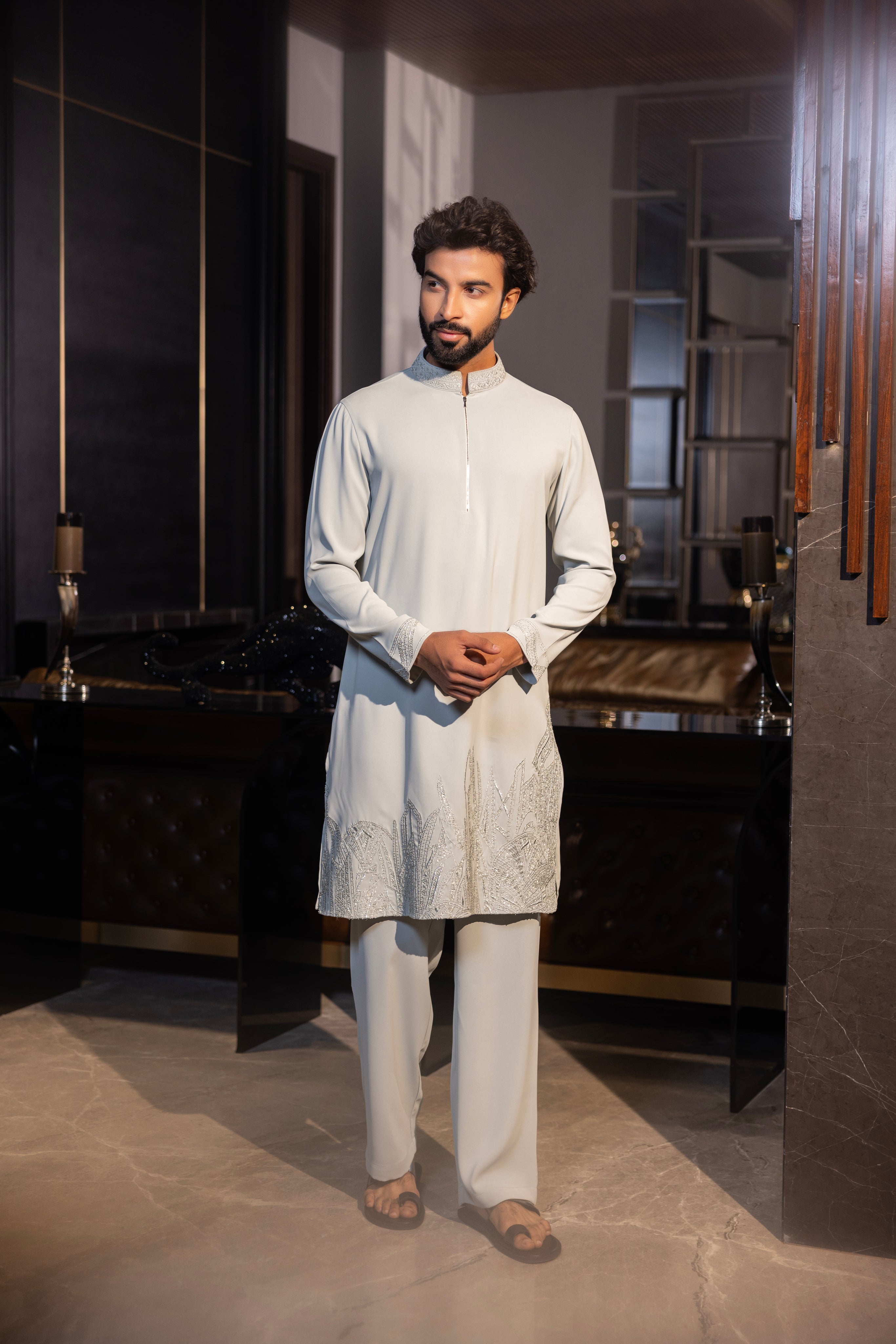 Mint green kurta with hand-embroidery detailing paired with a matching aligadhi set.