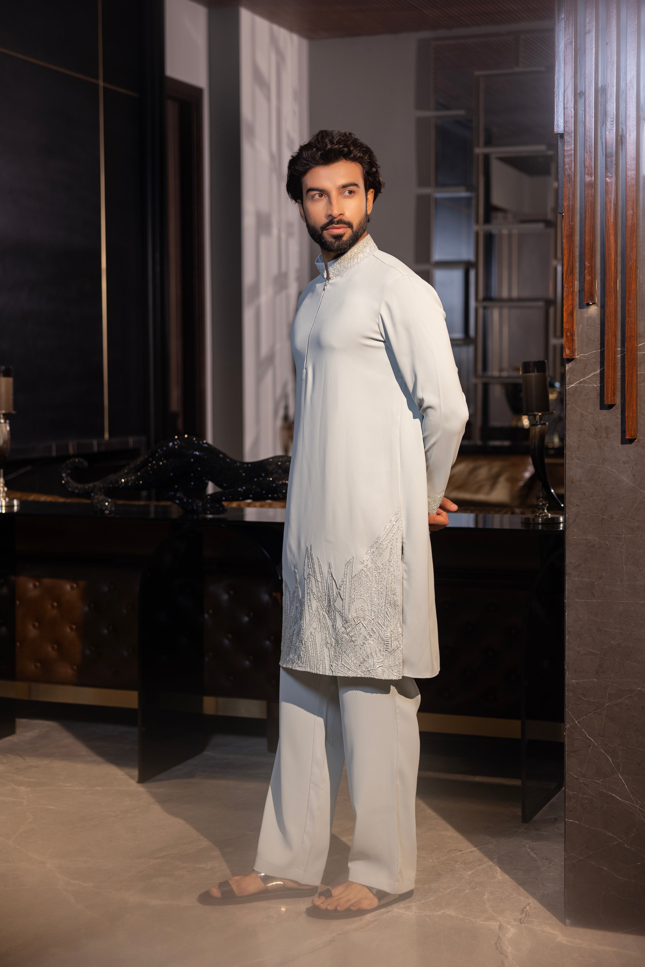 Mint green kurta with hand-embroidery detailing paired with a matching aligadhi set.