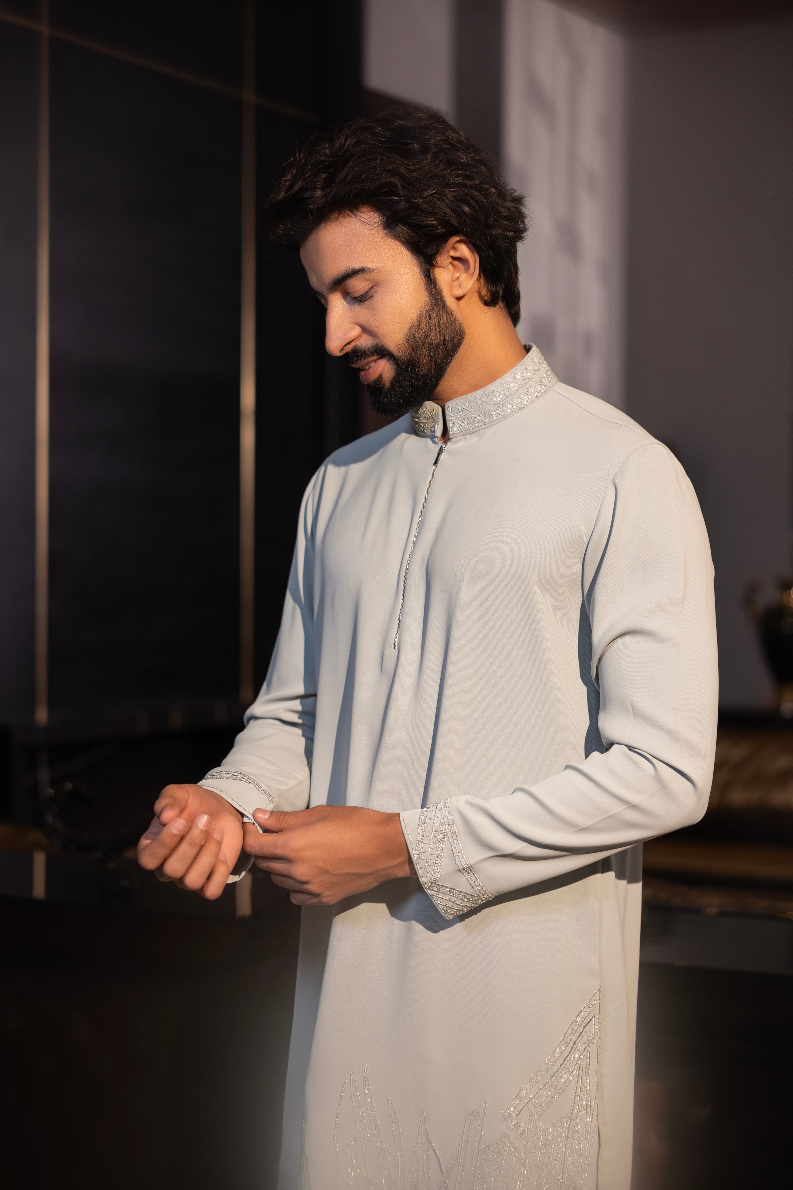 Mint green kurta with hand-embroidery detailing paired with a matching aligadhi set.