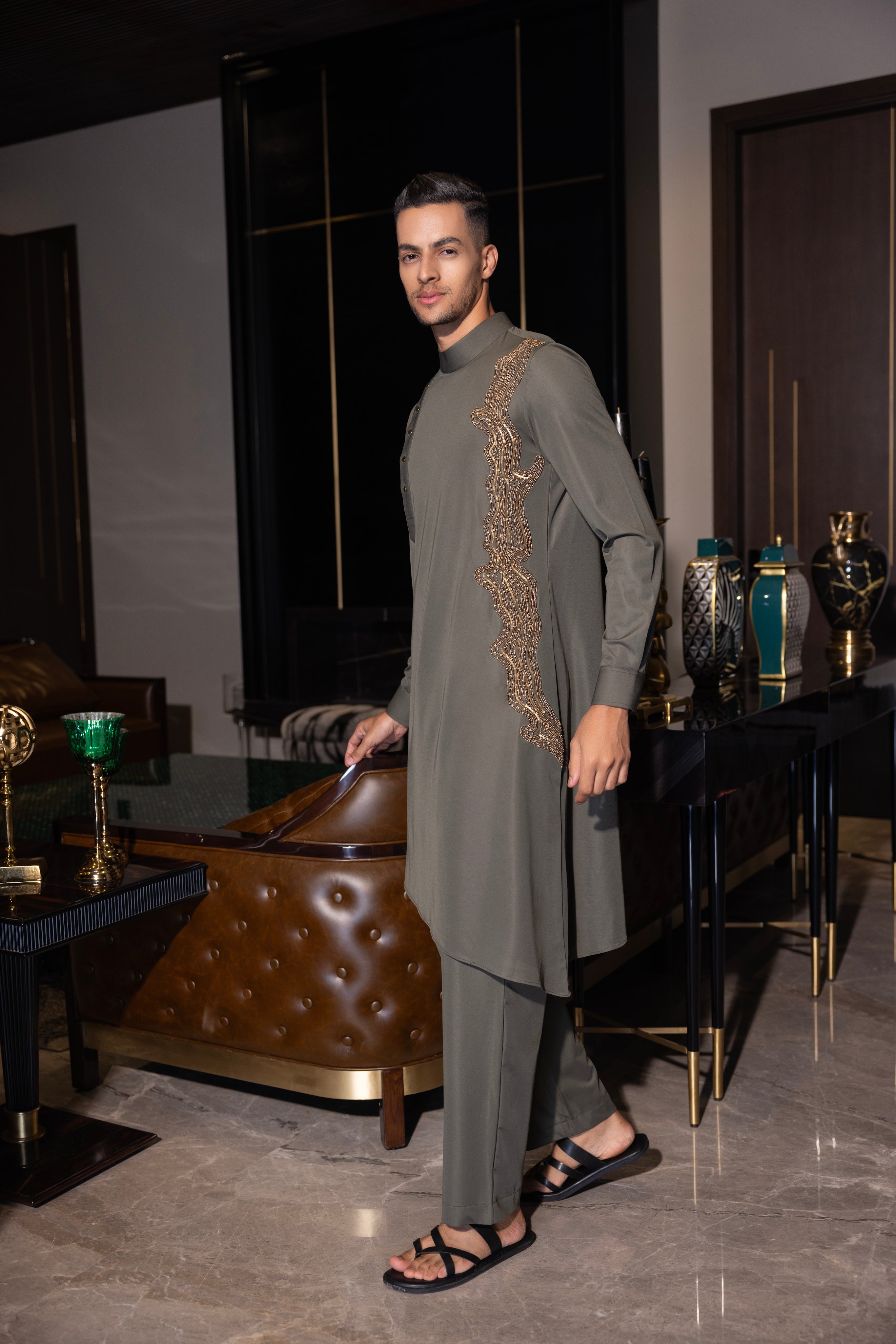 Olive green kurta with gold hand-embroidery detailing paired with a matching aligadhi set.