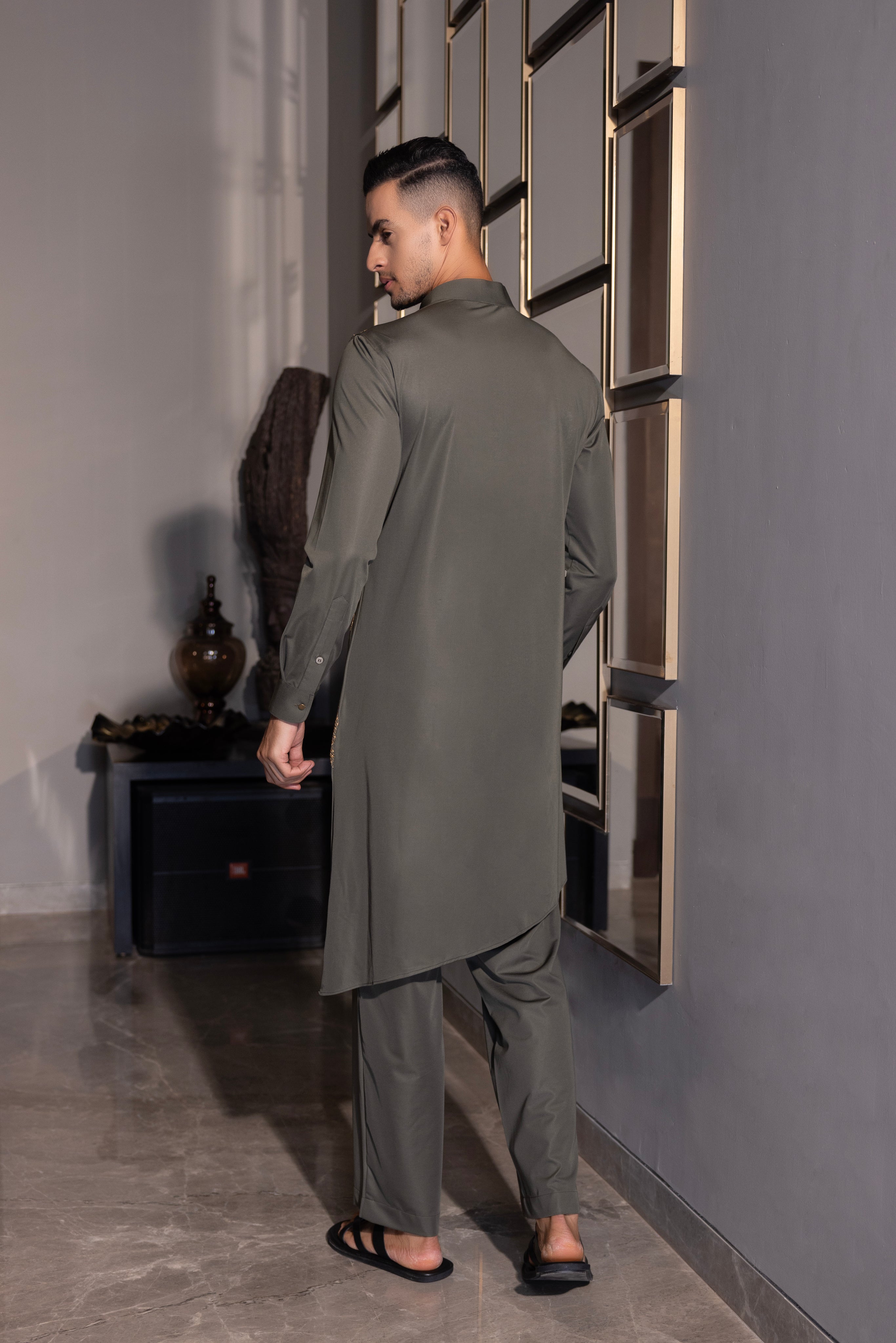 Olive green kurta with gold hand-embroidery detailing paired with a matching aligadhi set.