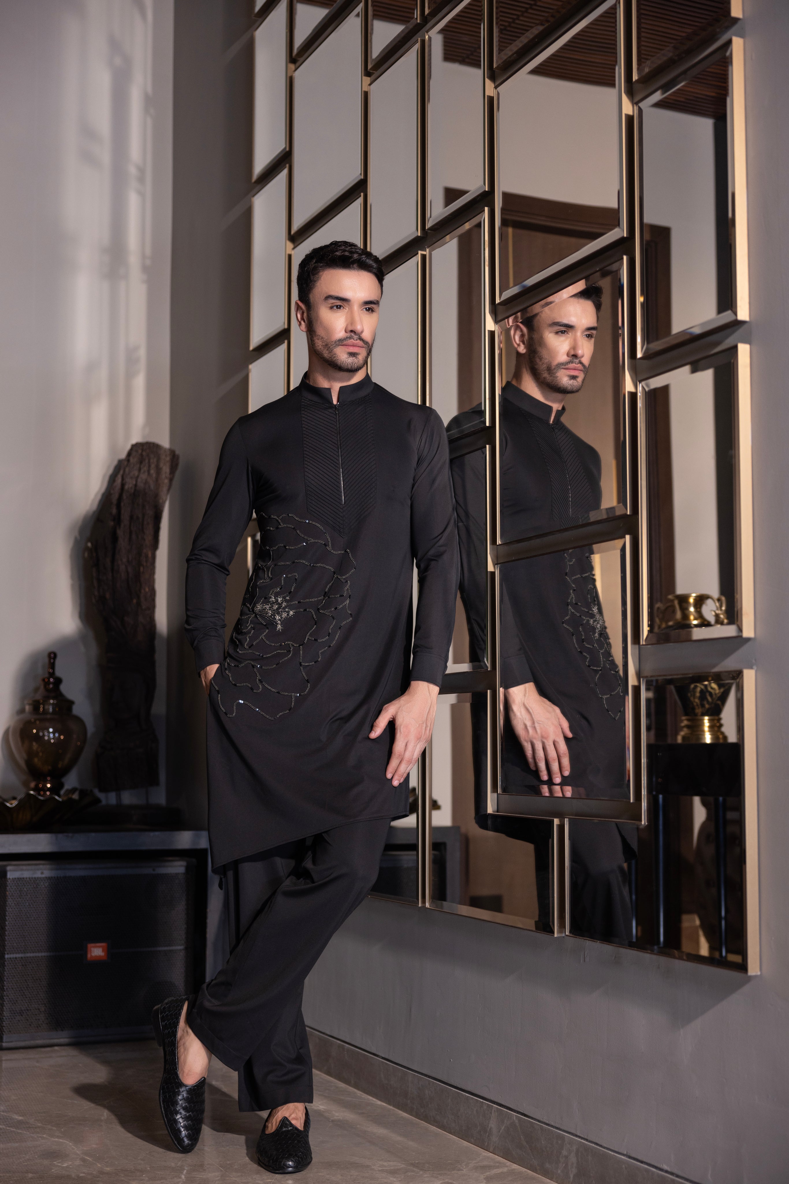 Black kurta with hand-embroidered flower motif & pleats detailing paired with a matching aligadhi set.