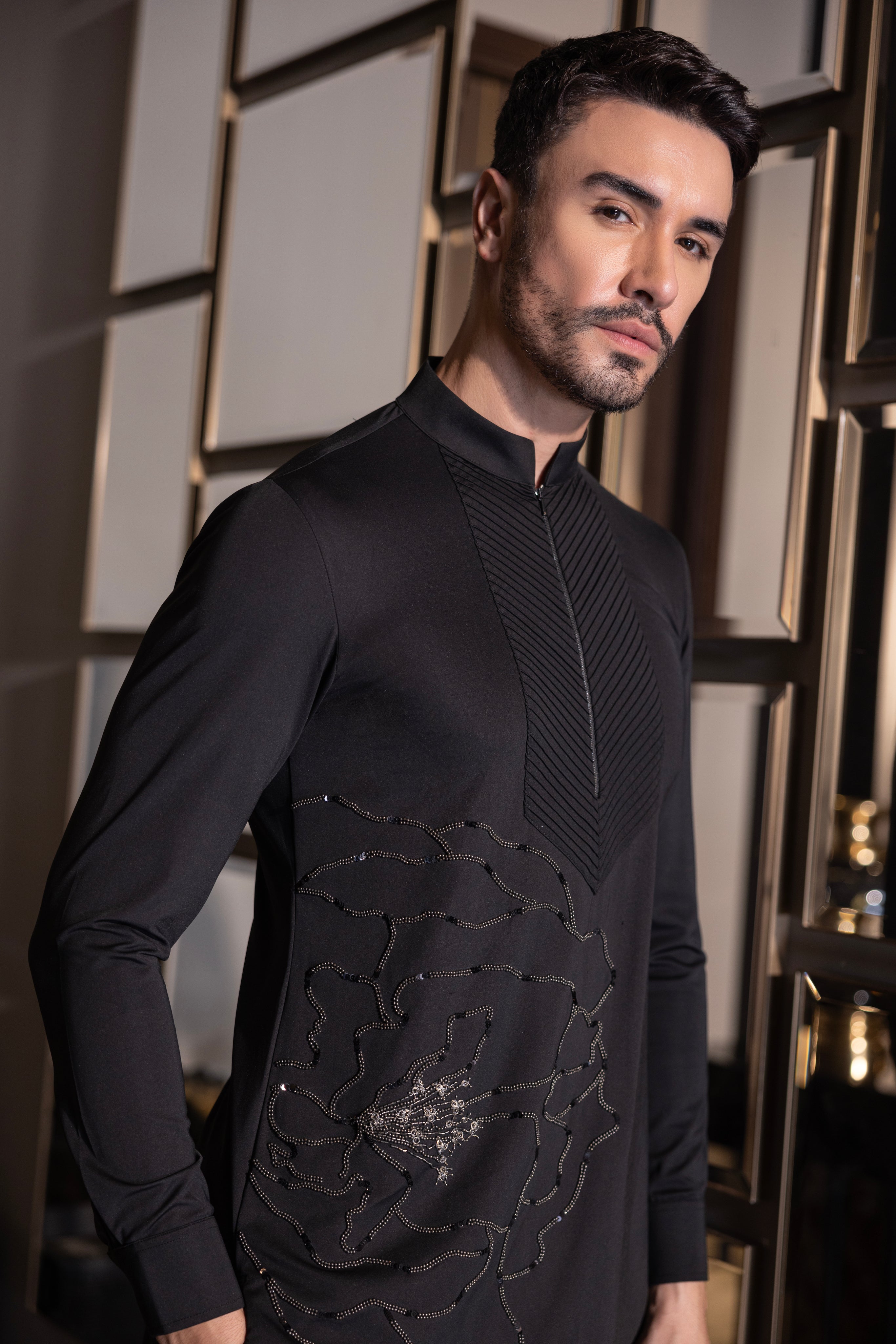 Black kurta with hand-embroidered flower motif & pleats detailing paired with a matching aligadhi set.