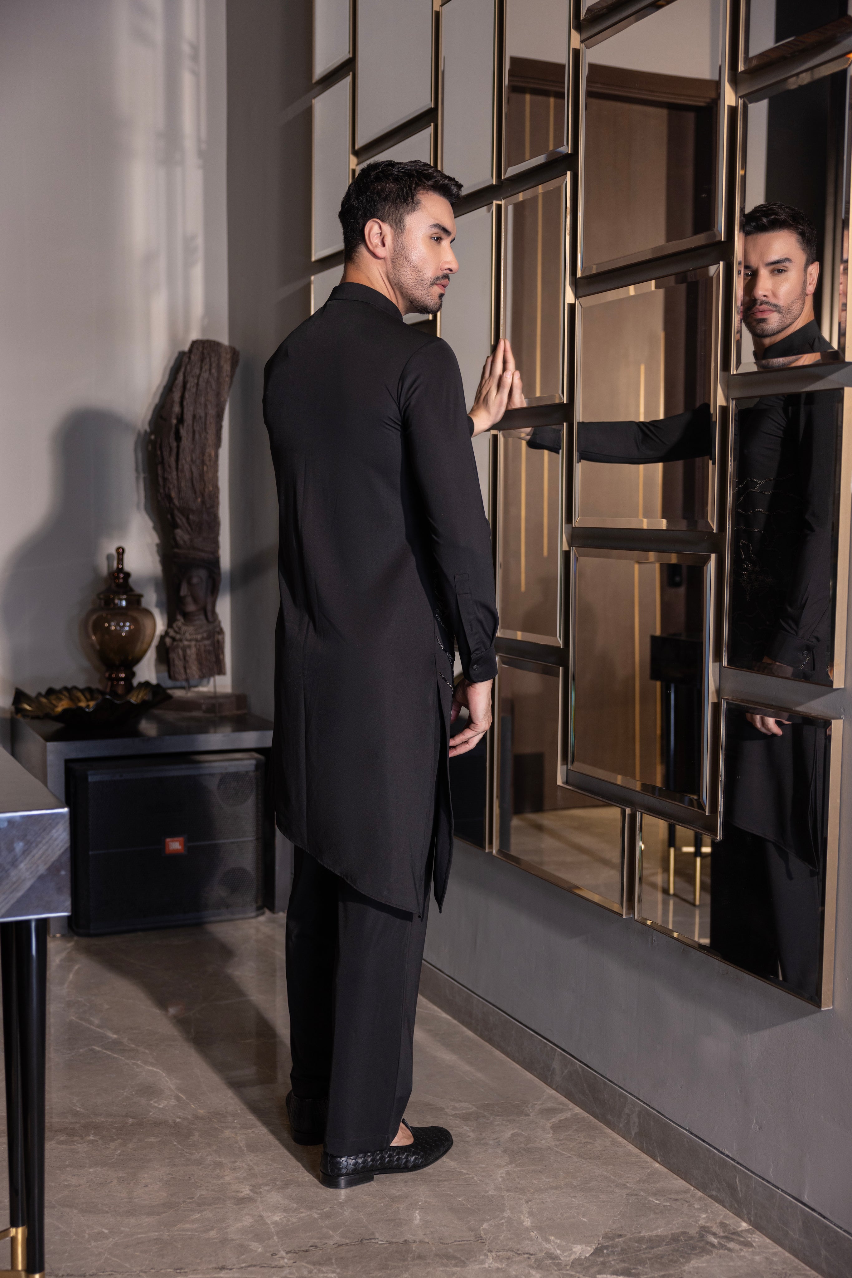 Black kurta with hand-embroidered flower motif & pleats detailing paired with a matching aligadhi set.