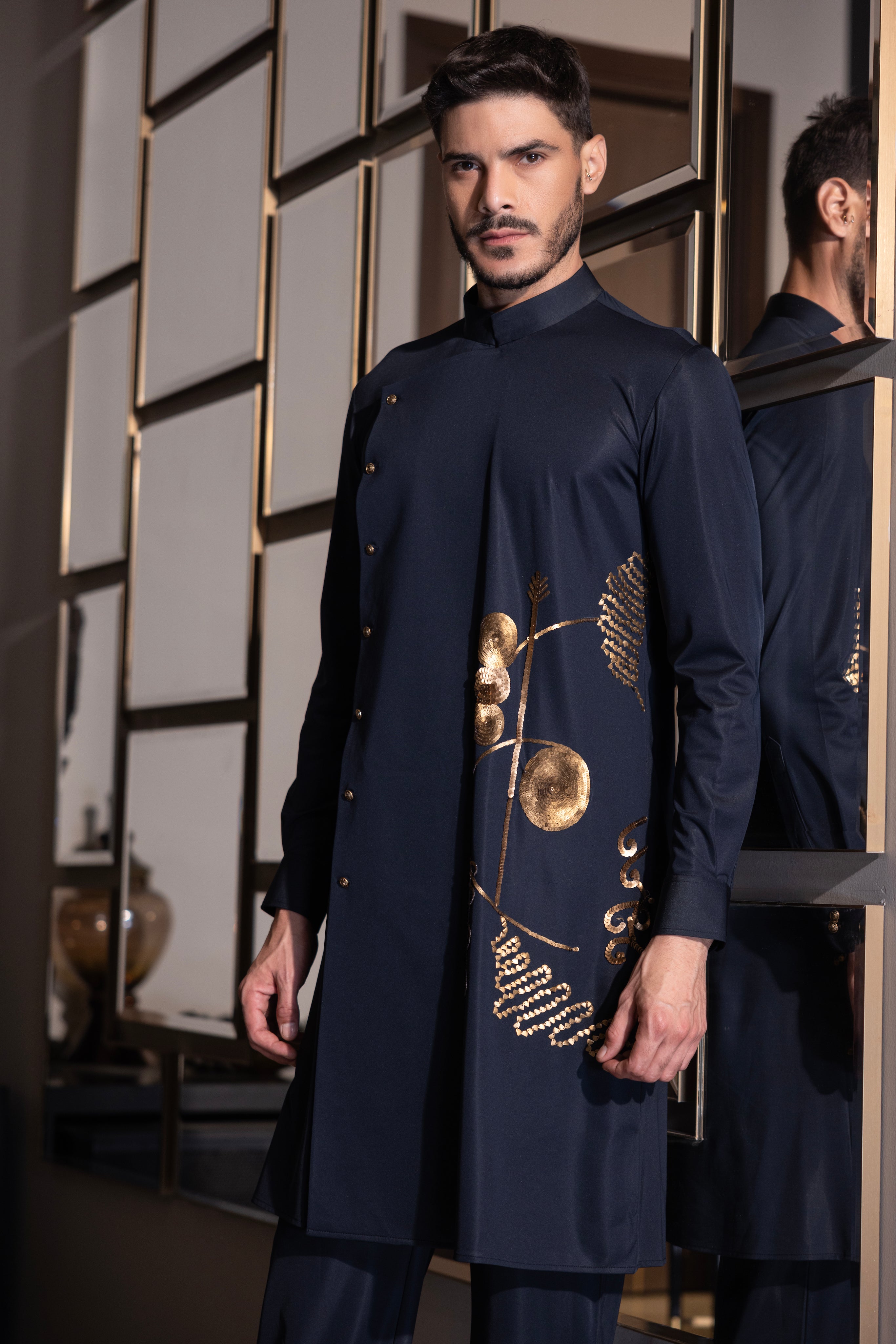 Navy Blue kurta with gold hand-embroidery detailing paired with a matching aligadhi set.