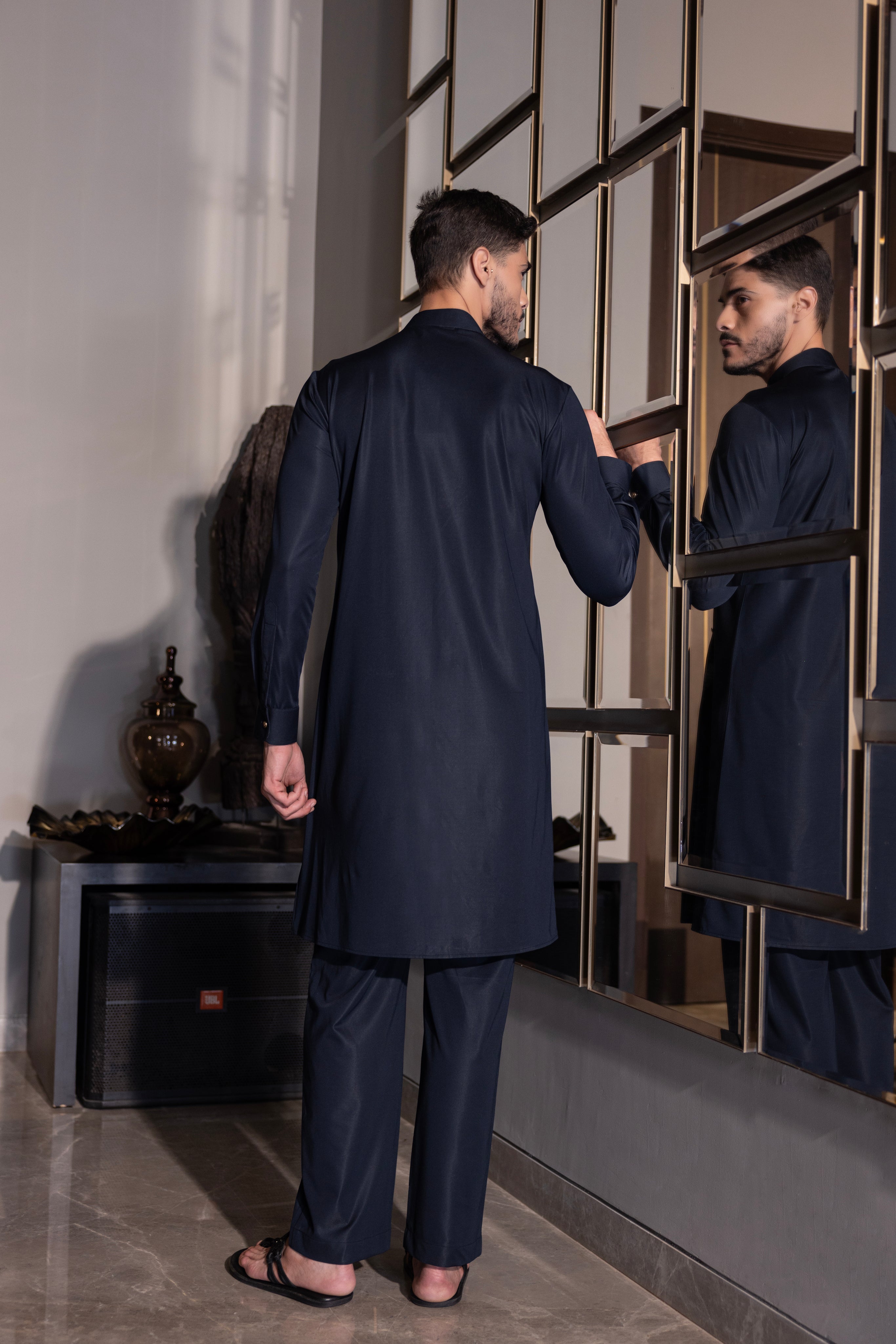 Navy Blue kurta with hand-embroidery detailing paired with a matching aligadhi set.