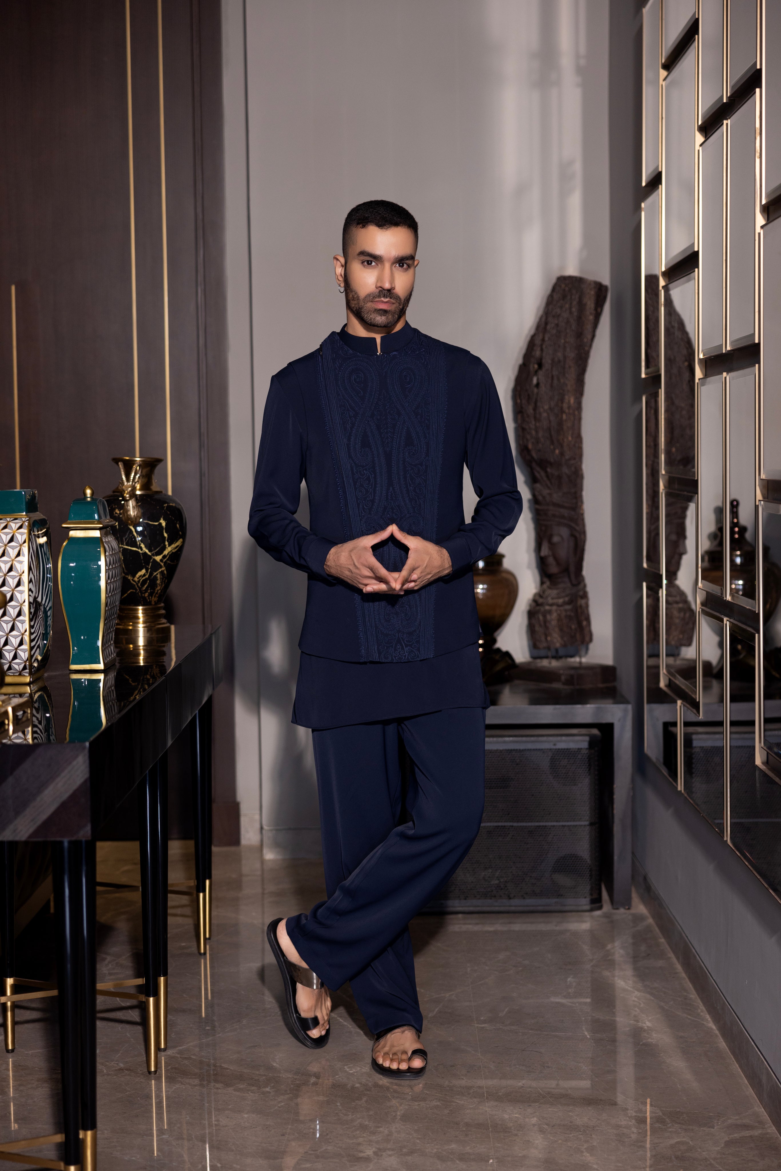 Navy Blue waistcoat with intricate montone hand-embroidery & size zipper paired with a matching kurta and  aligadhi set.