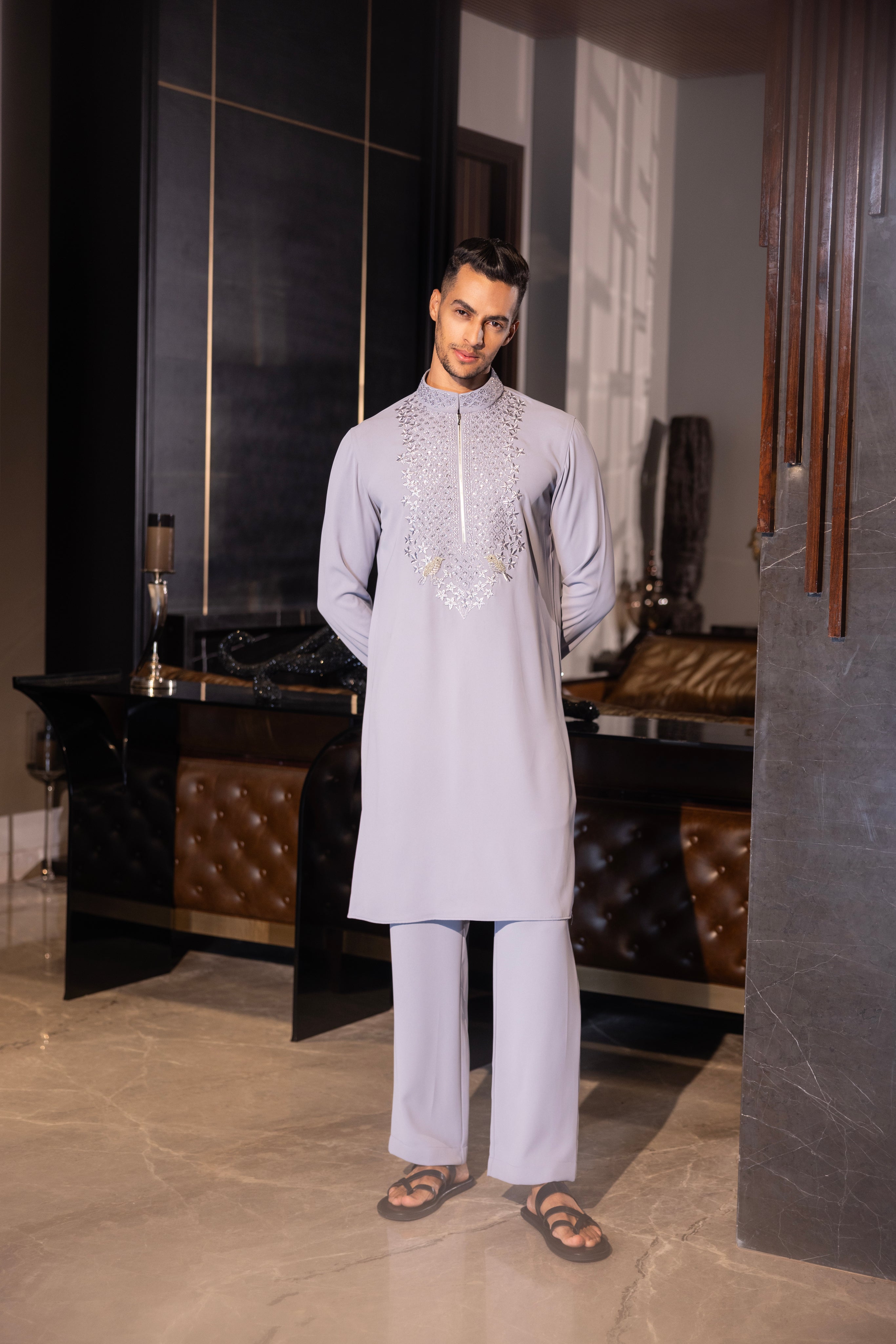 Lilac kurta with hand-embroidery detailing paired with a matching aligadhi set.