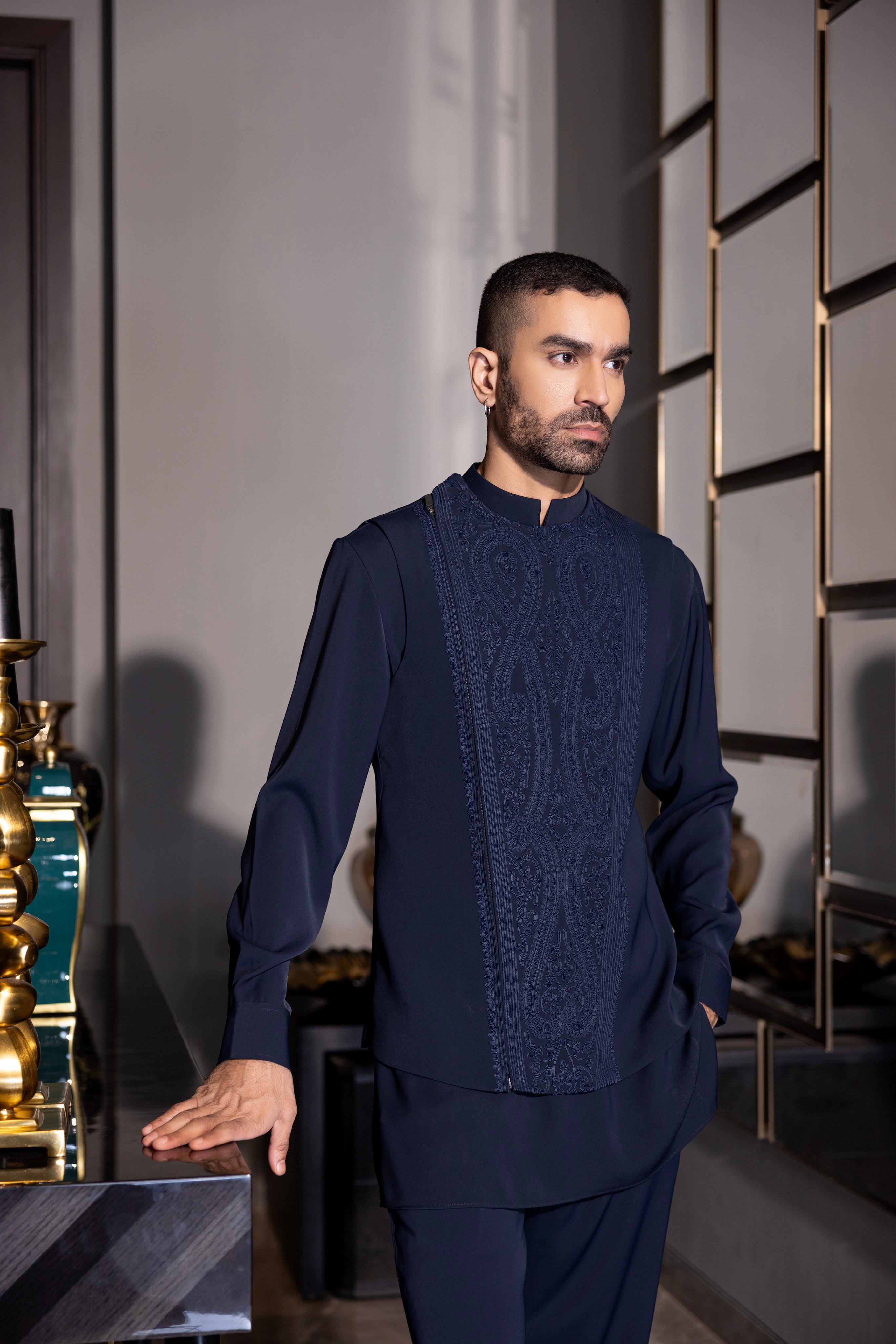 Navy Blue waistcoat with intricate montone hand-embroidery & size zipper paired with a matching kurta and  aligadhi set.