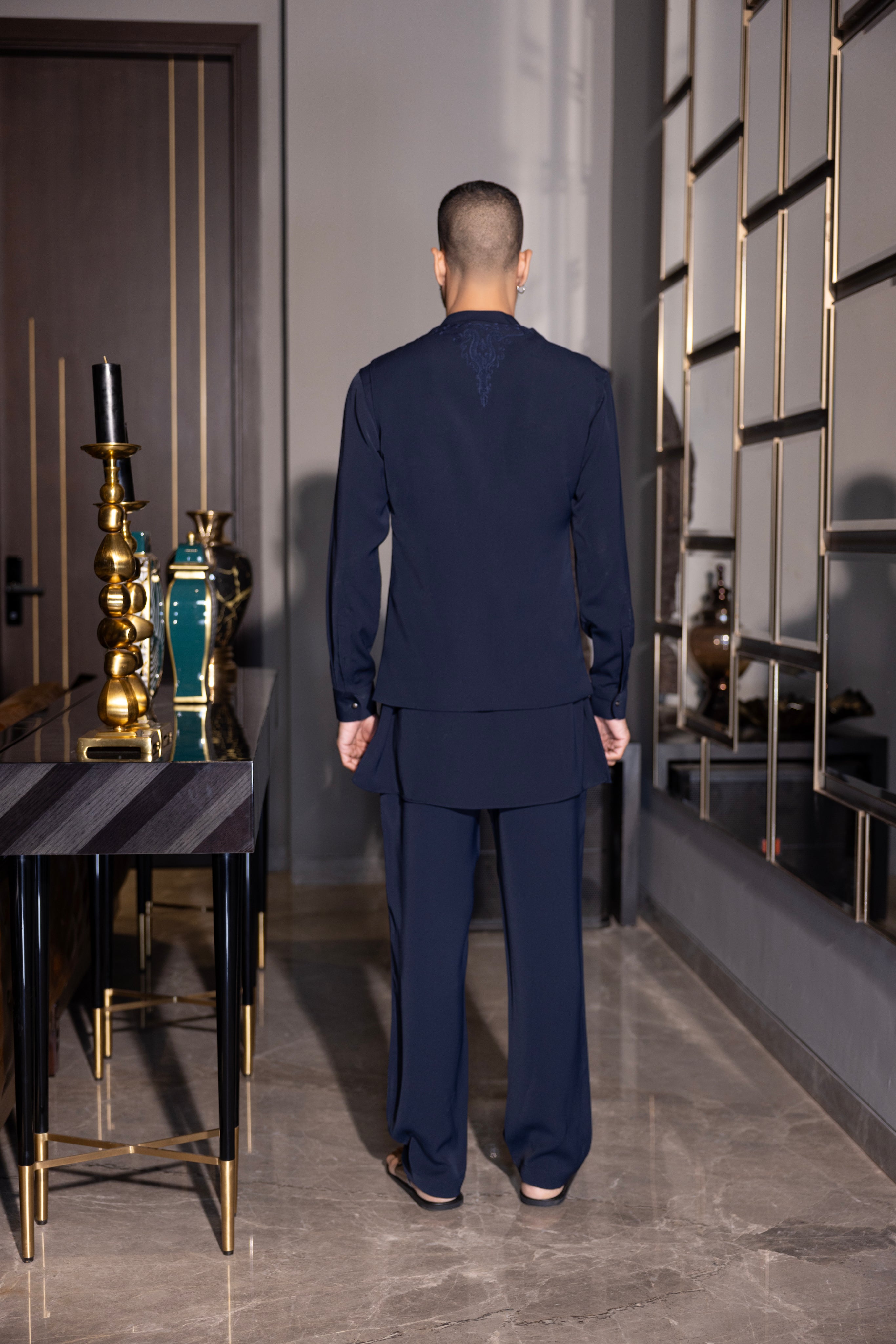 Navy Blue waistcoat with intricate montone hand-embroidery & size zipper paired with a matching kurta and  aligadhi set.