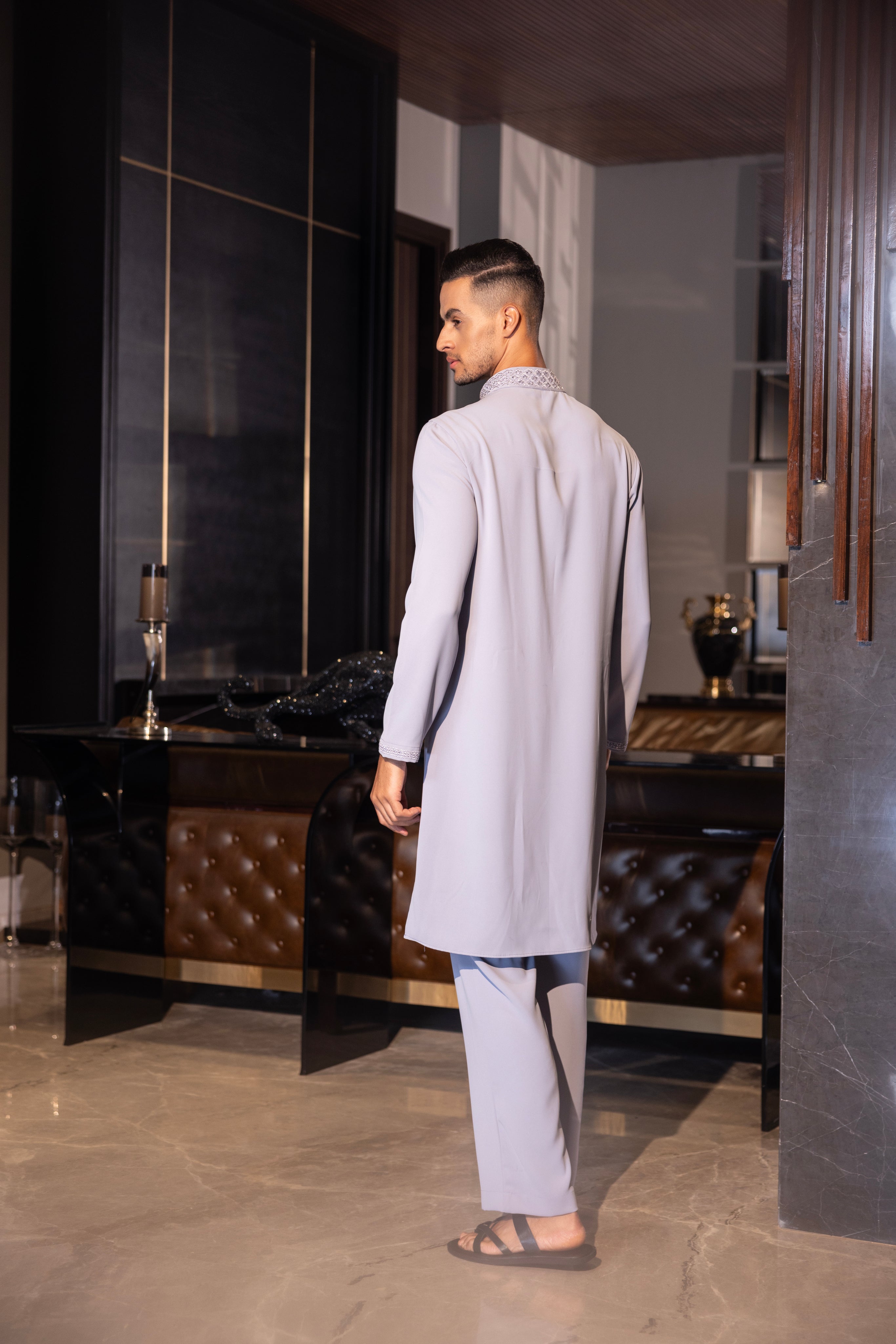 Lilac kurta with hand-embroidery detailing paired with a matching aligadhi set.