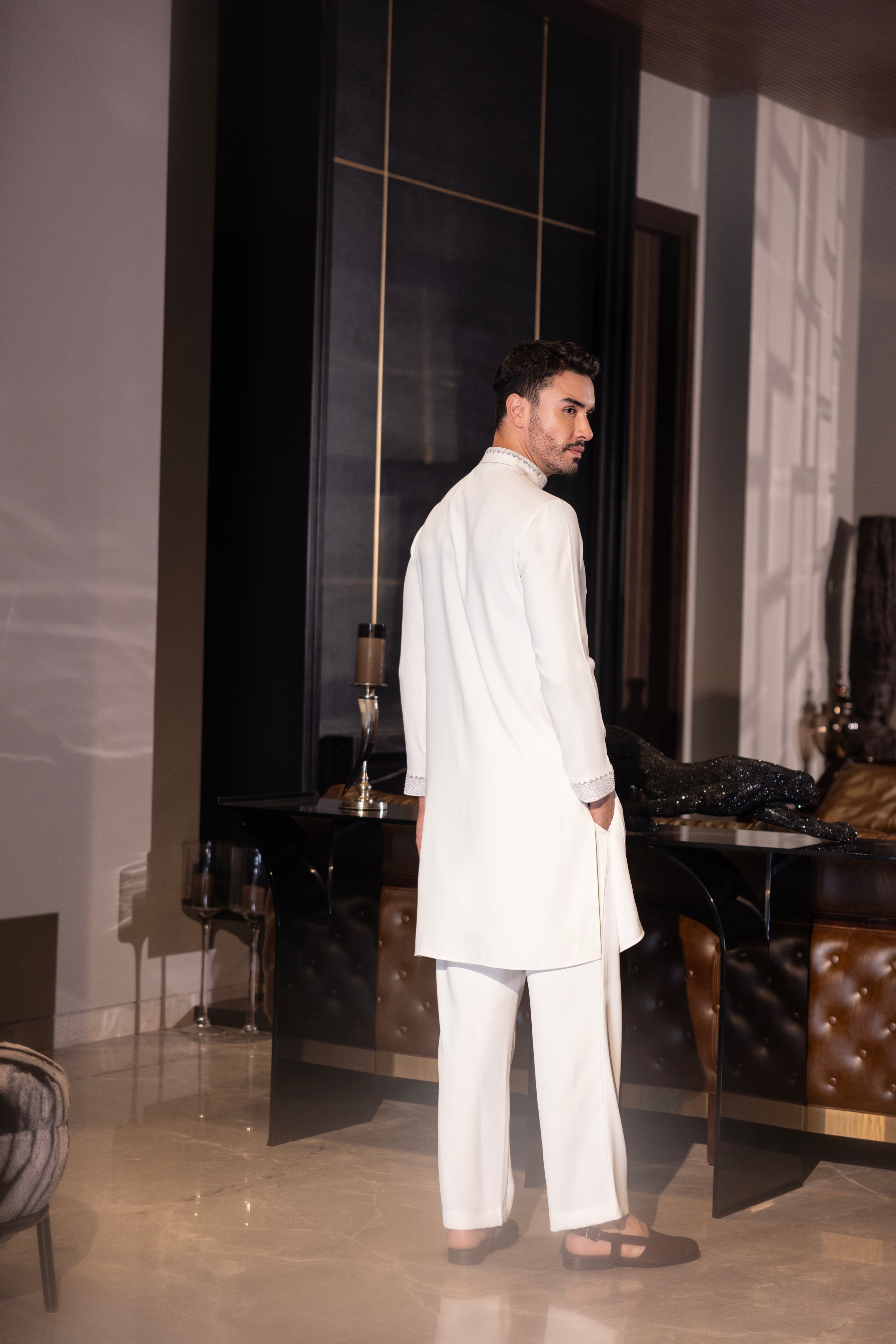 Ivory kurta with hand-embroidery detailing paired with a matching aligadhi set.