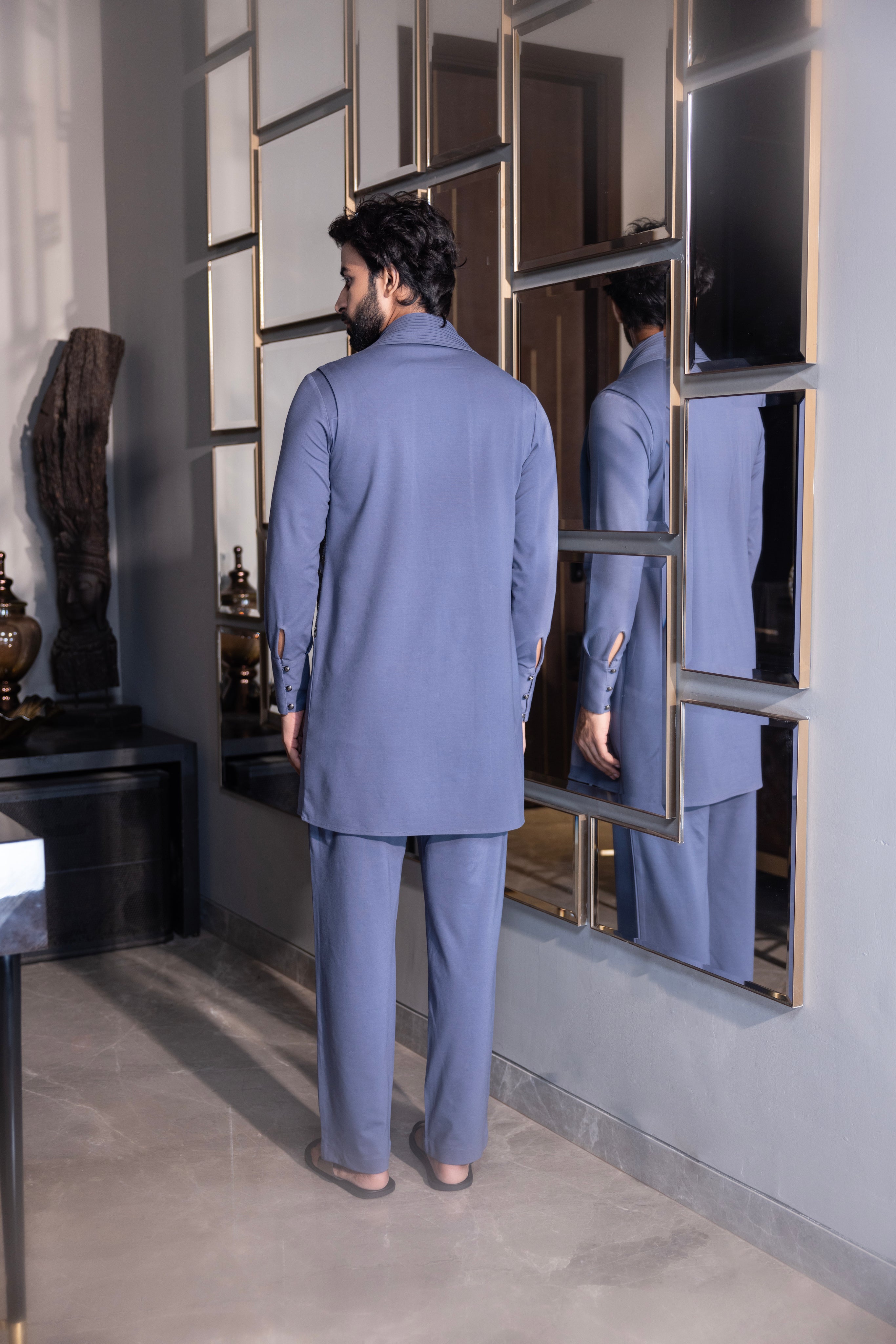 Purple kurta with hand-embroidery & draping details paired with a matching aligadhi set.
