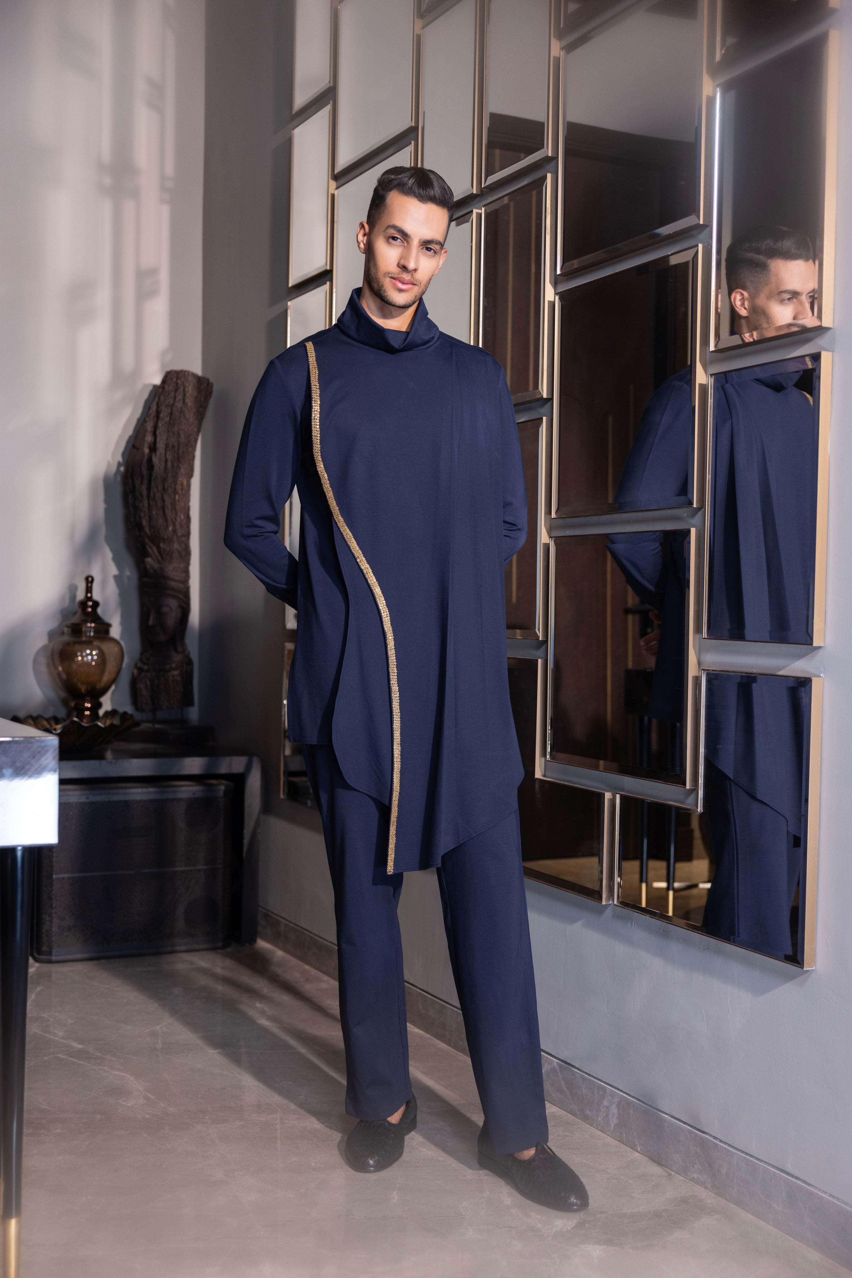 Navy Blue draped kurta with hand-embroidery detailing paired with a matching aligadhi set.