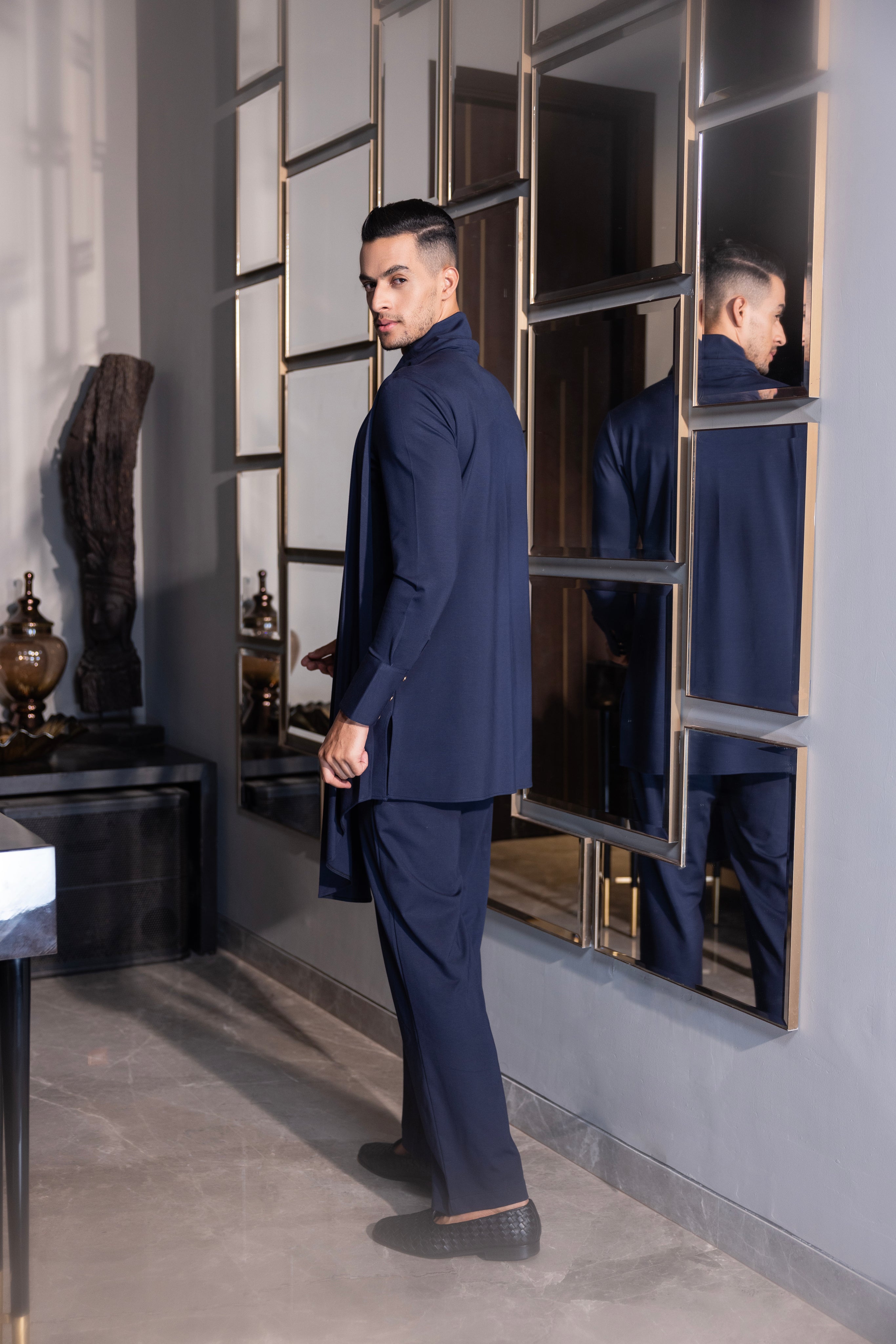 Navy Blue draped kurta with hand-embroidery detailing paired with a matching aligadhi set.