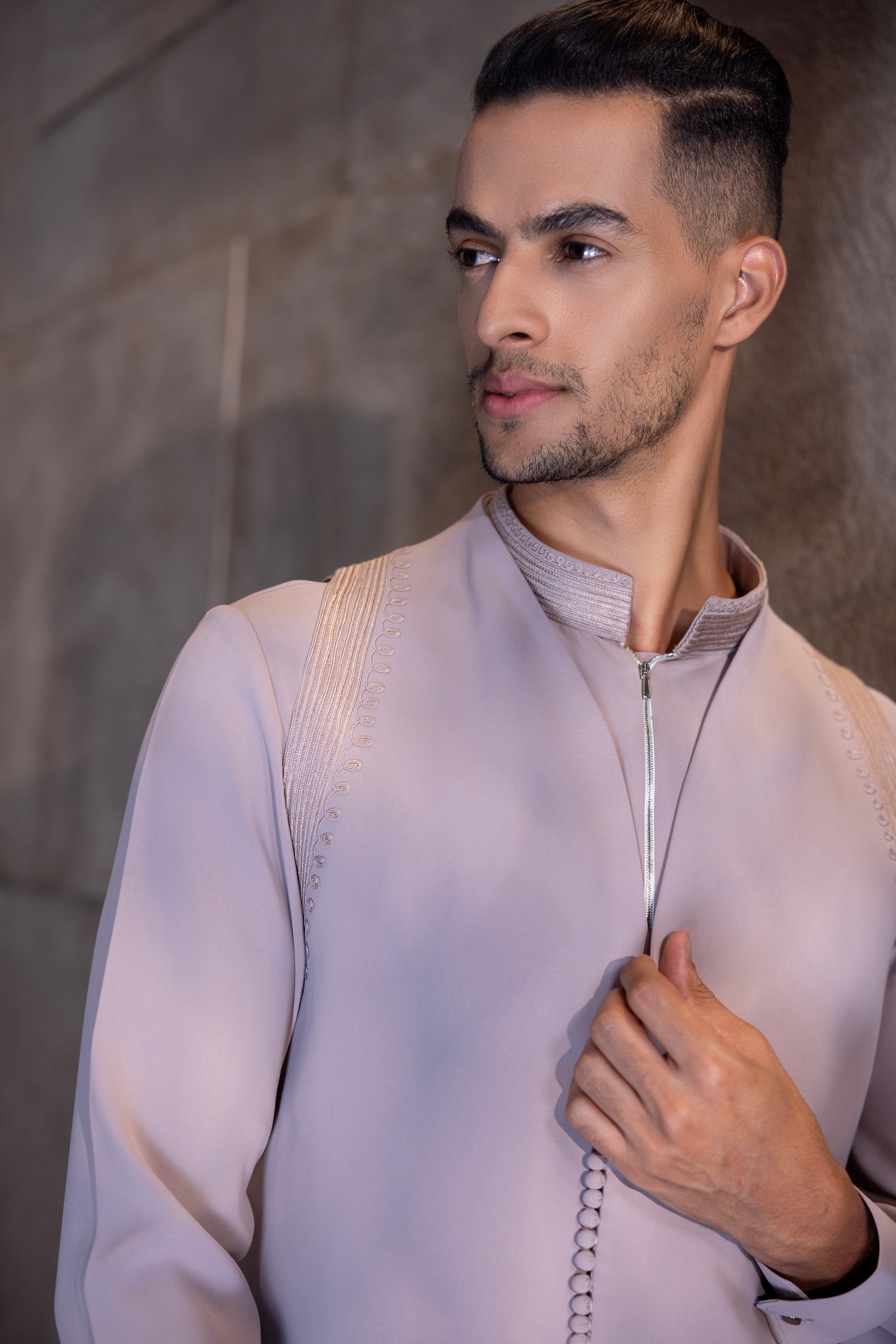 Onion Pink buttoned-up waistcoat with montone hand-embroidery paired with a draped kurta and matching aligadhi set.