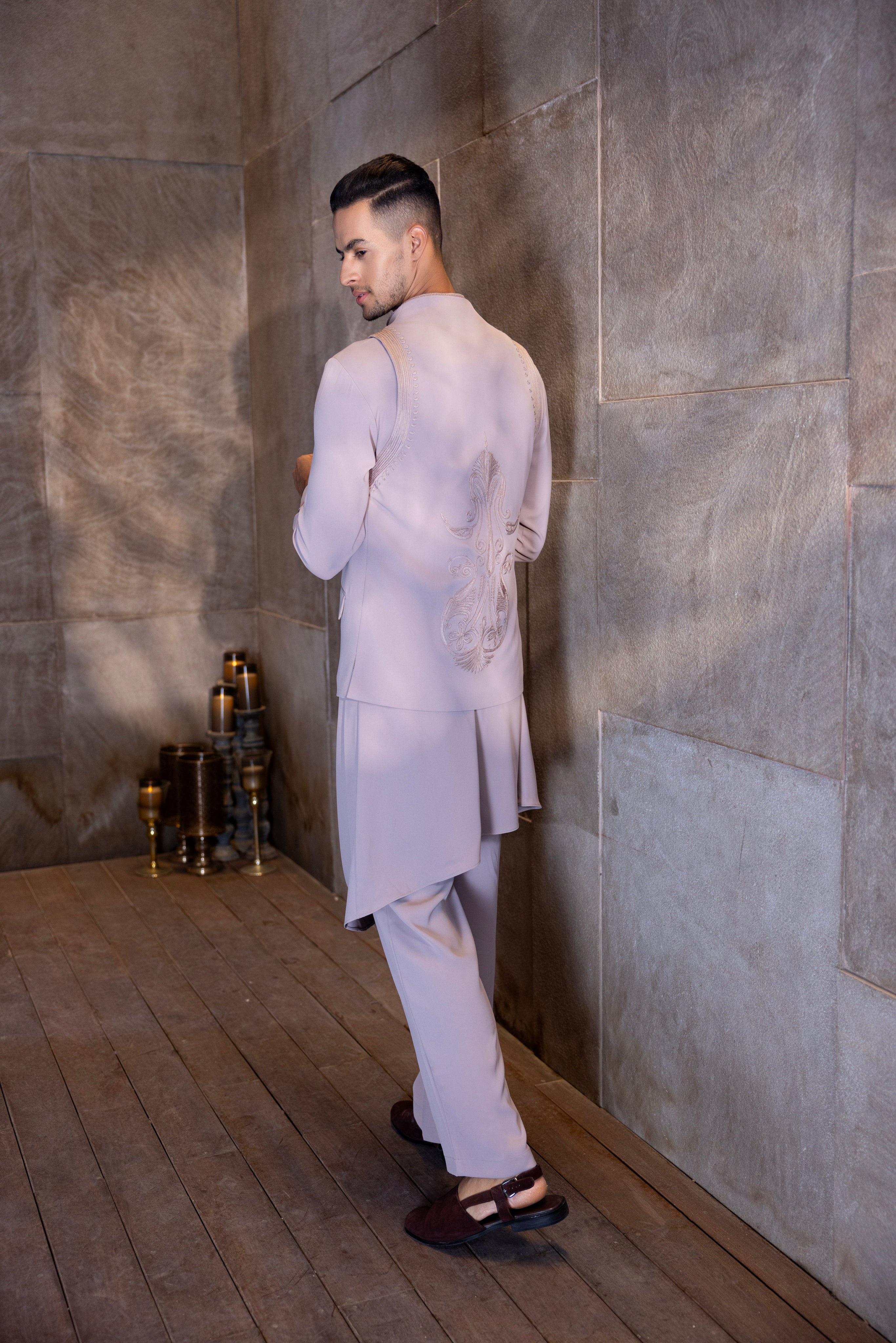 Onion Pink buttoned-up waistcoat with montone hand-embroidery paired with a draped kurta and matching aligadhi set.