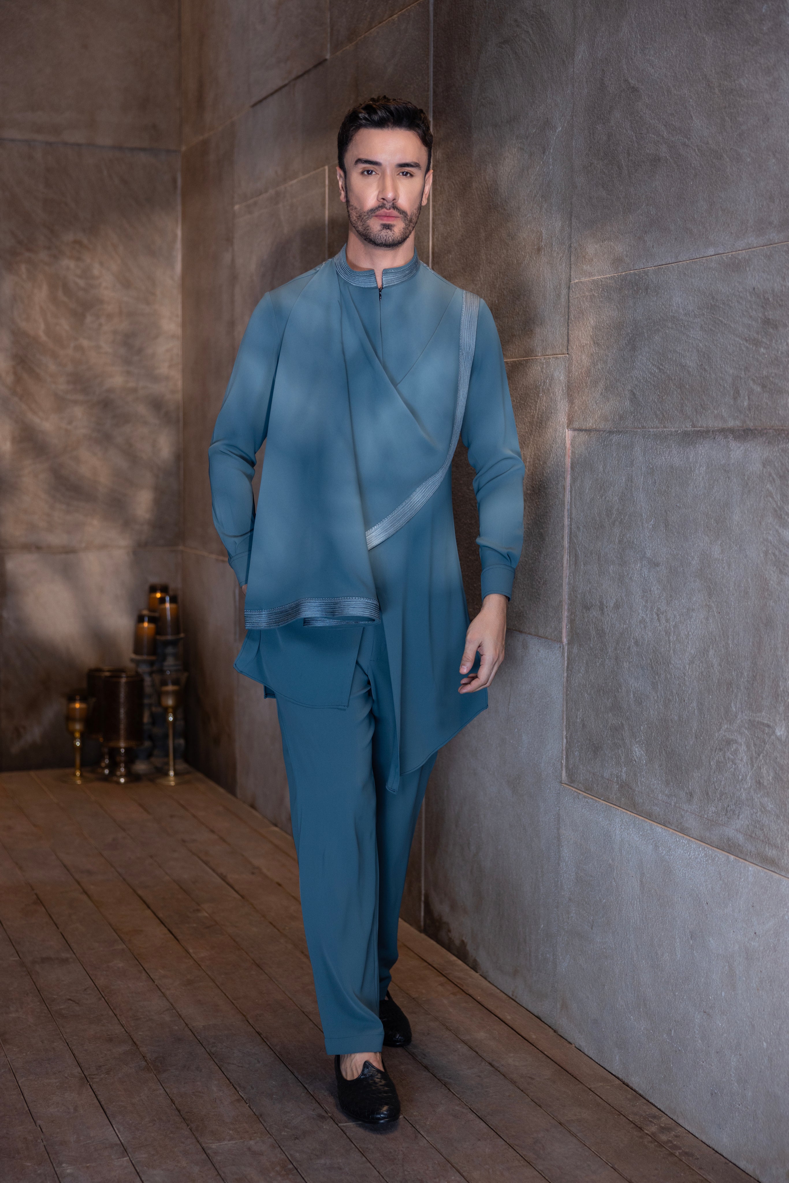 Turquoise hand-embroidered kurta with draping details paired with a matching aligadhi set.