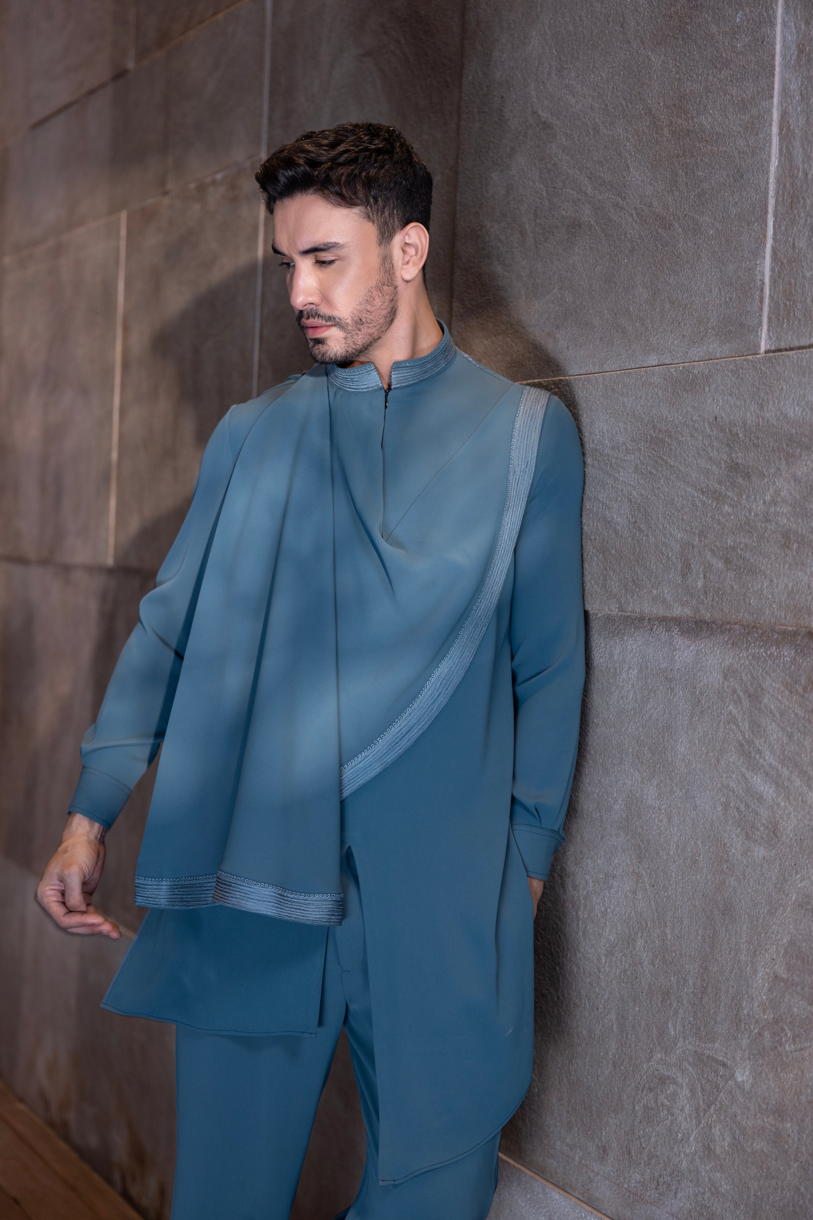 Turquoise hand-embroidered kurta with draping details paired with a matching aligadhi set.