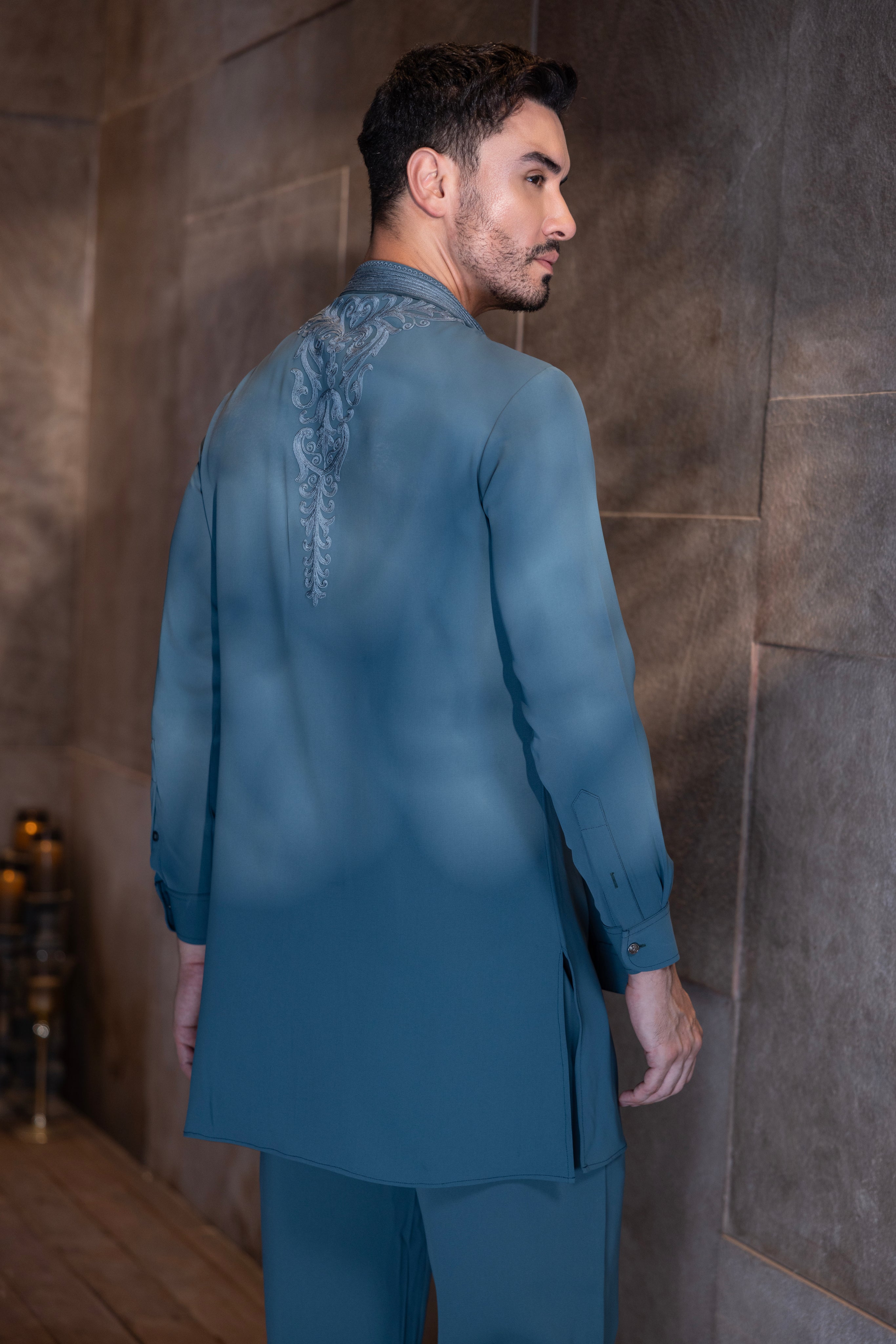 Turquoise hand-embroidered kurta with draping details paired with a matching aligadhi set.