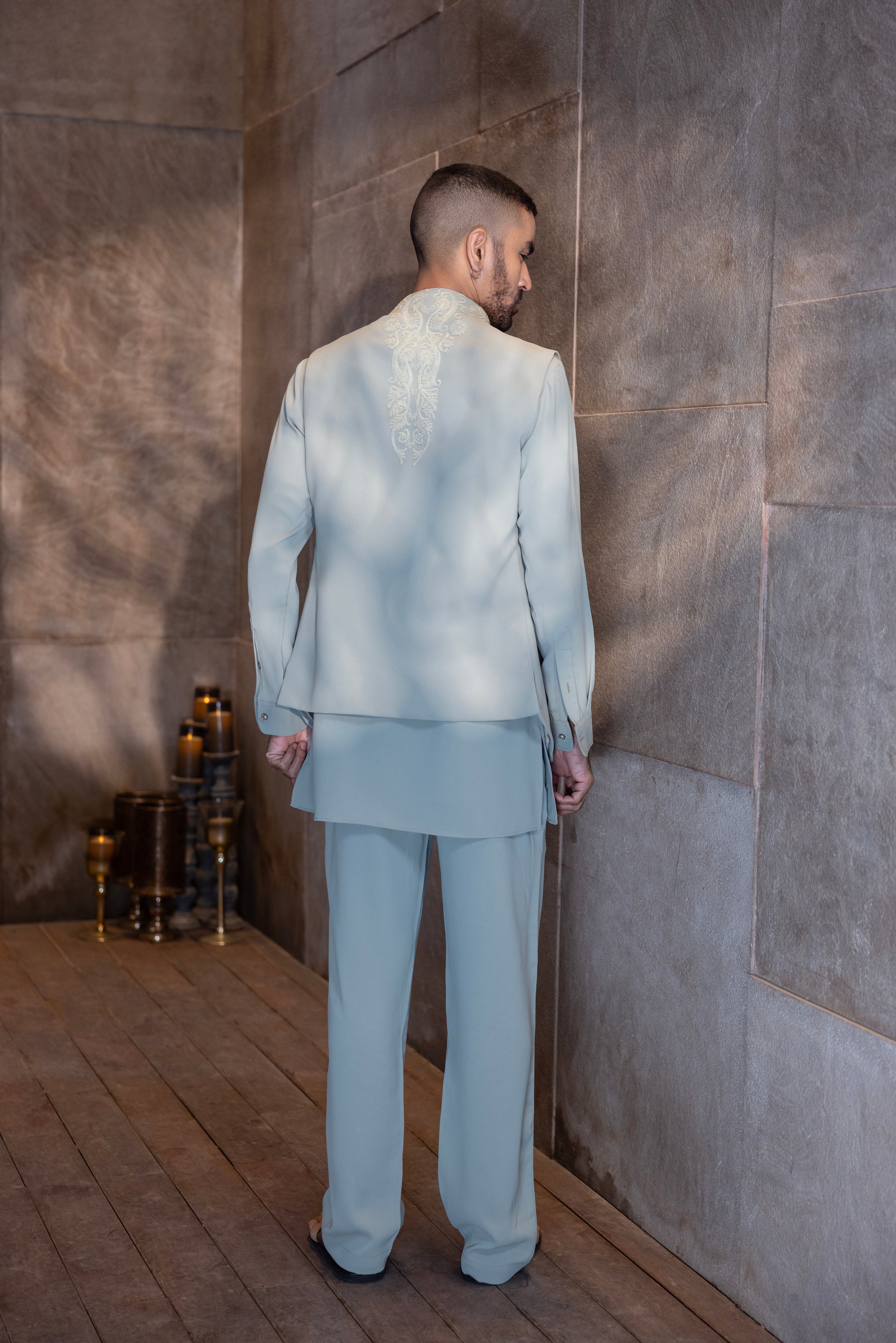 Pista Green draped waistcoat with  montone hand-embroidery paired with a matching kurta and aligadhi set.