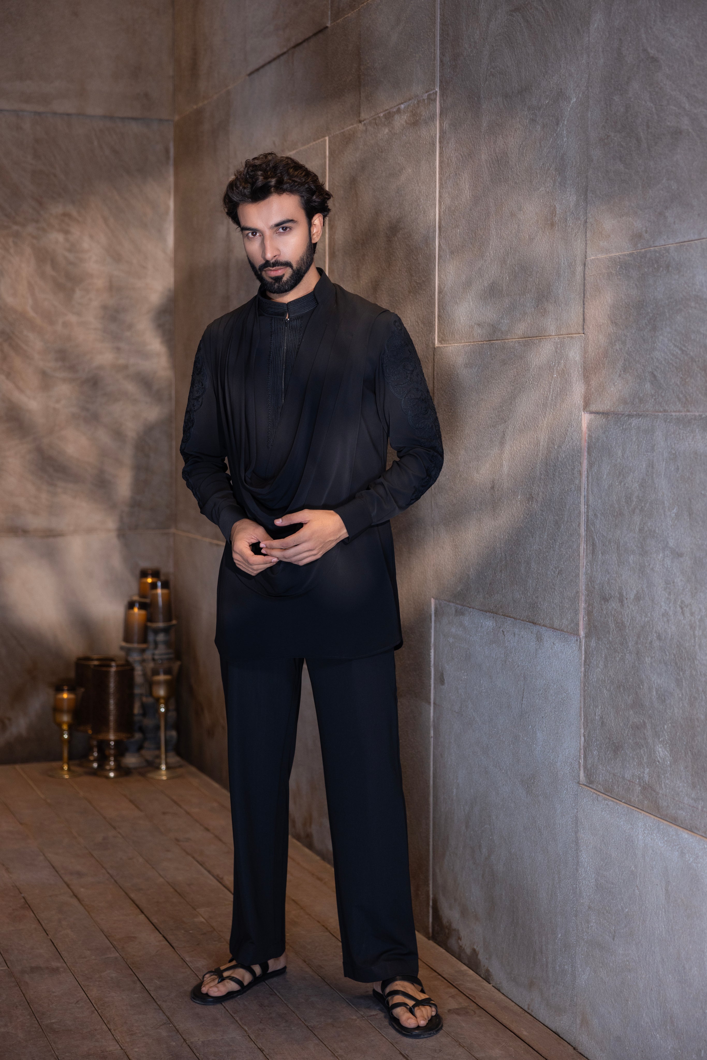 Black hand-embroidered kurta with cowl detailing paired with a matching aligadhi set.
