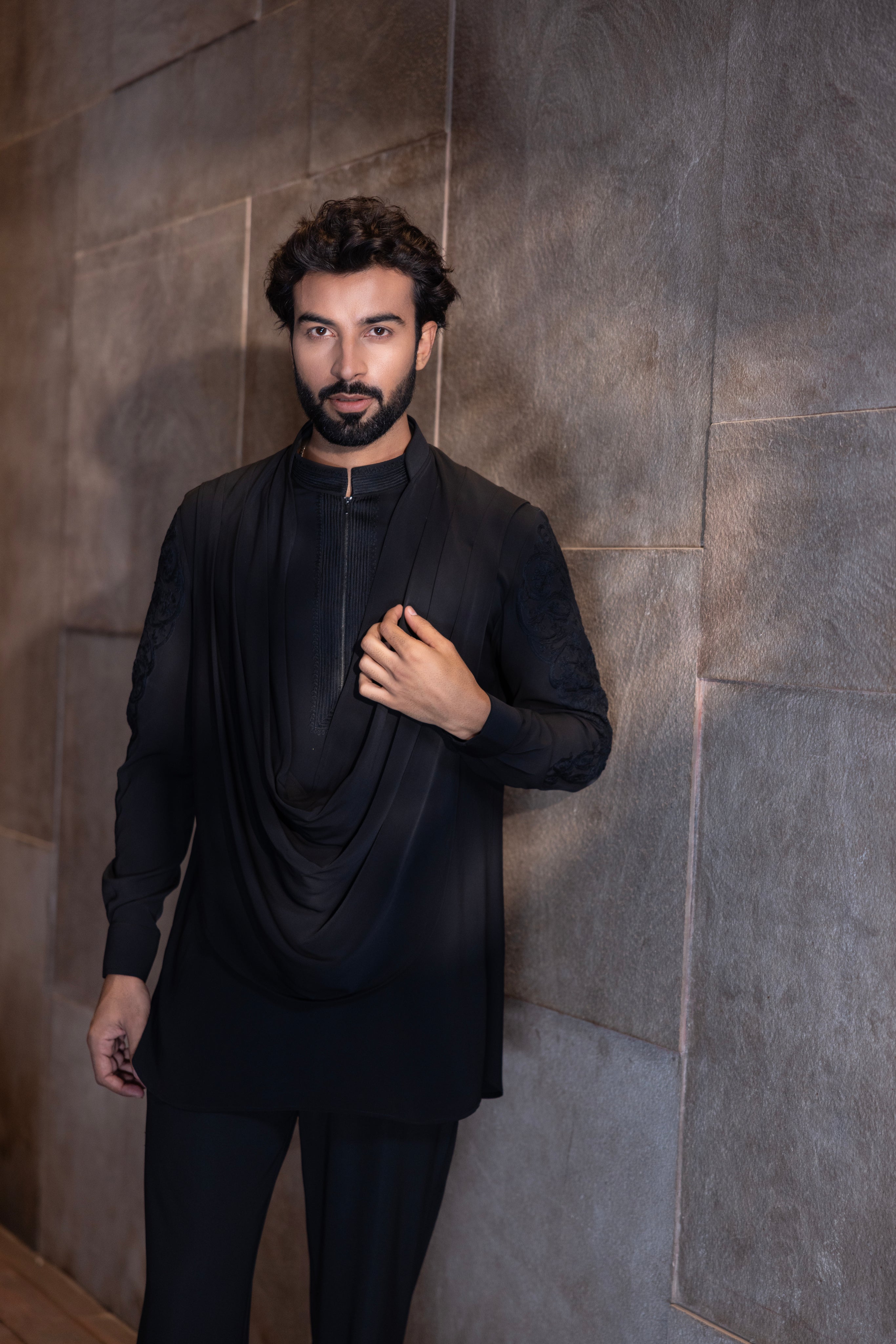 Black hand-embroidered kurta with cowl detailing paired with a matching aligadhi set.