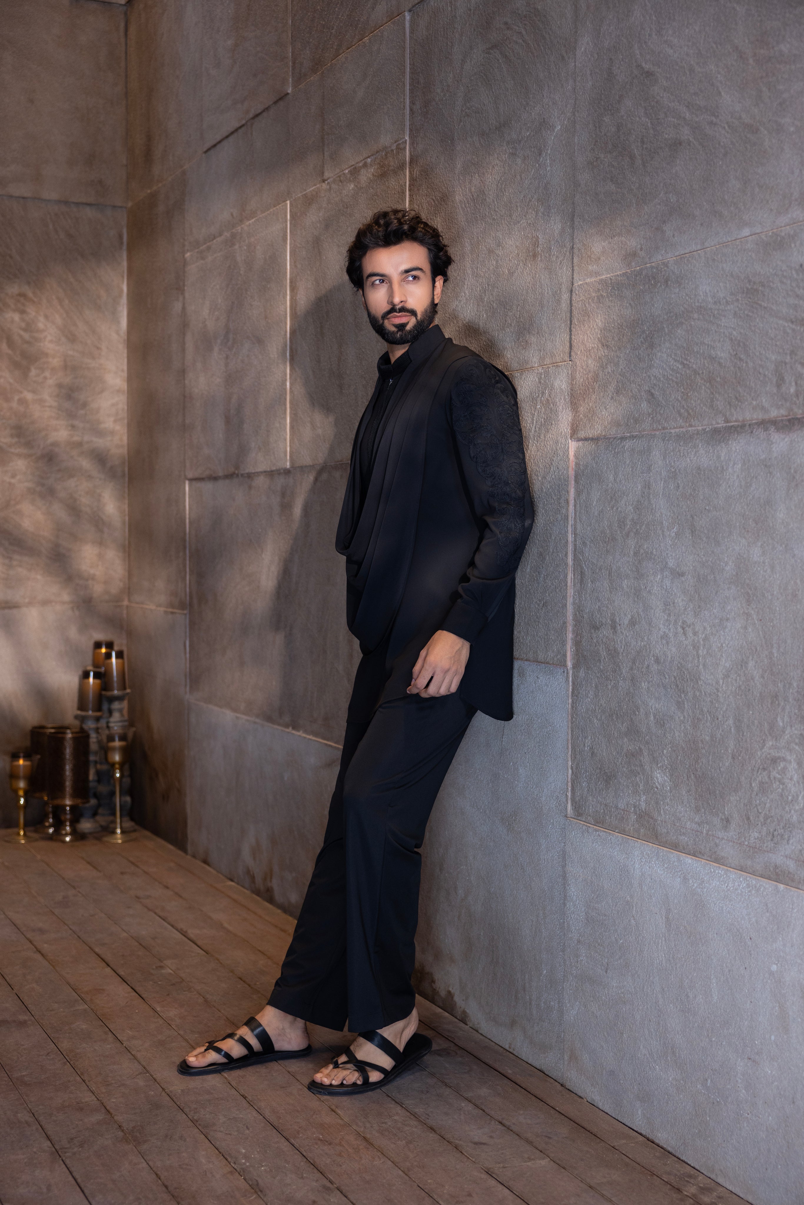 Black hand-embroidered kurta with cowl detailing paired with a matching aligadhi set.