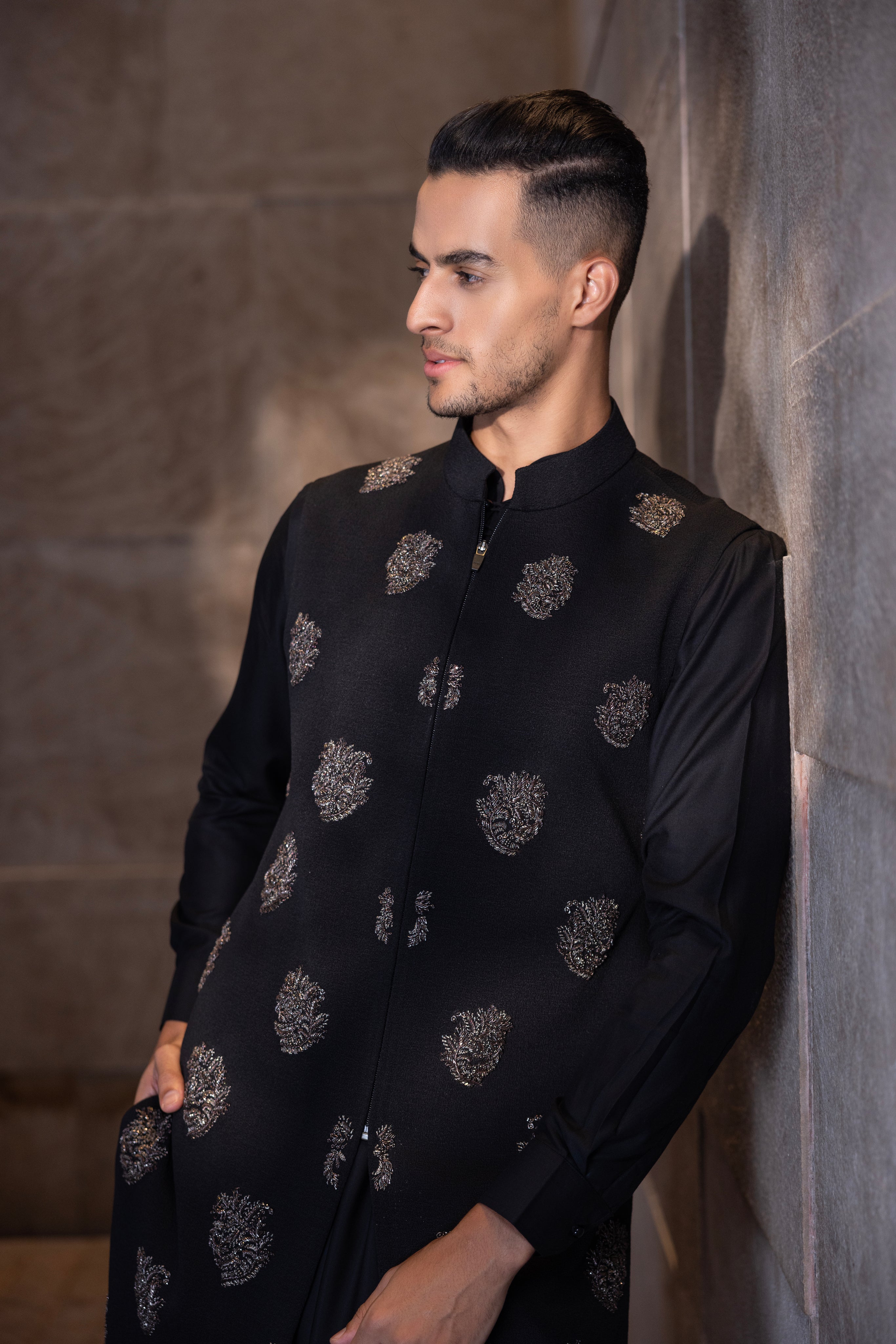 Black long hand-embroidered texturex knit waistcoat paired with a kali kurta and aligadhi set.